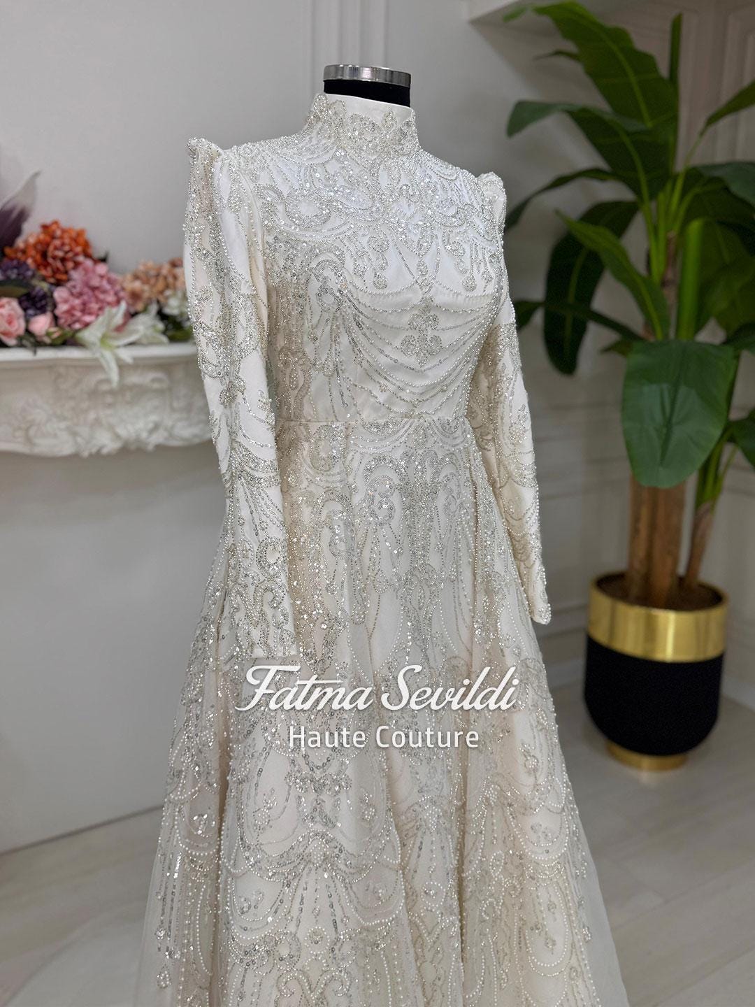 Elegant ivory Fatma Sevildi veiled hijab wedding gown with silver beading
