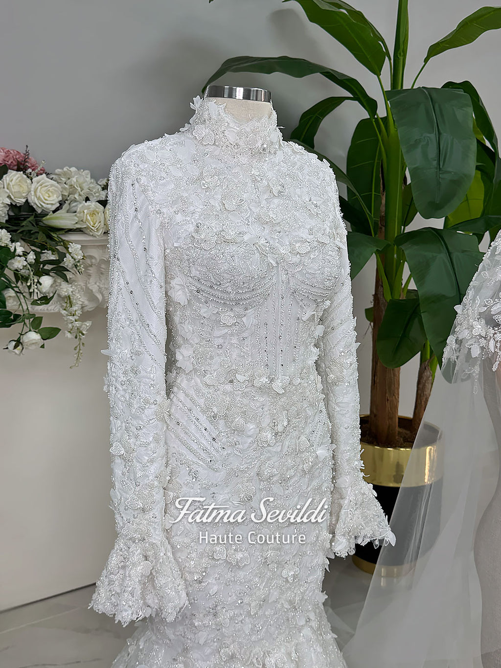 3-in-1 white hijab wedding dress with a beaded mermaid gown, detachable overskirt and long sleeve high-neck bridal topper. Convertible modest bridal set with dimensional floral lace and a coordinating lace veil.