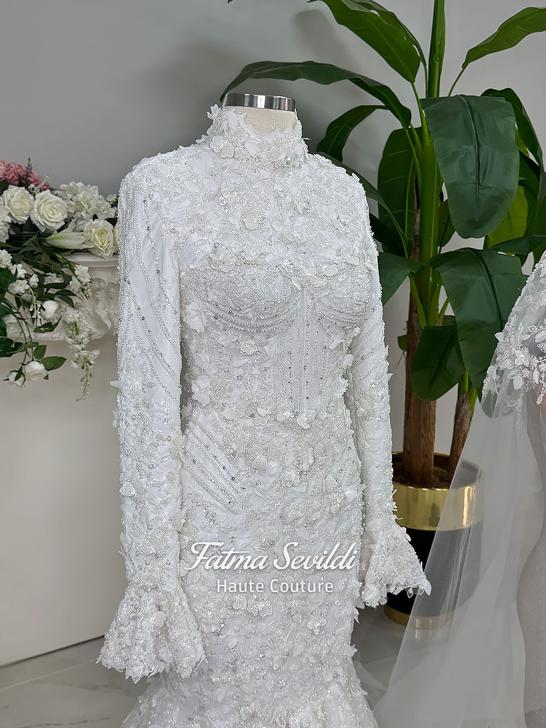 3-in-1 white hijab wedding dress with a beaded mermaid gown, detachable overskirt and long sleeve high-neck bridal topper. Convertible modest bridal set with dimensional floral lace and a coordinating lace veil.