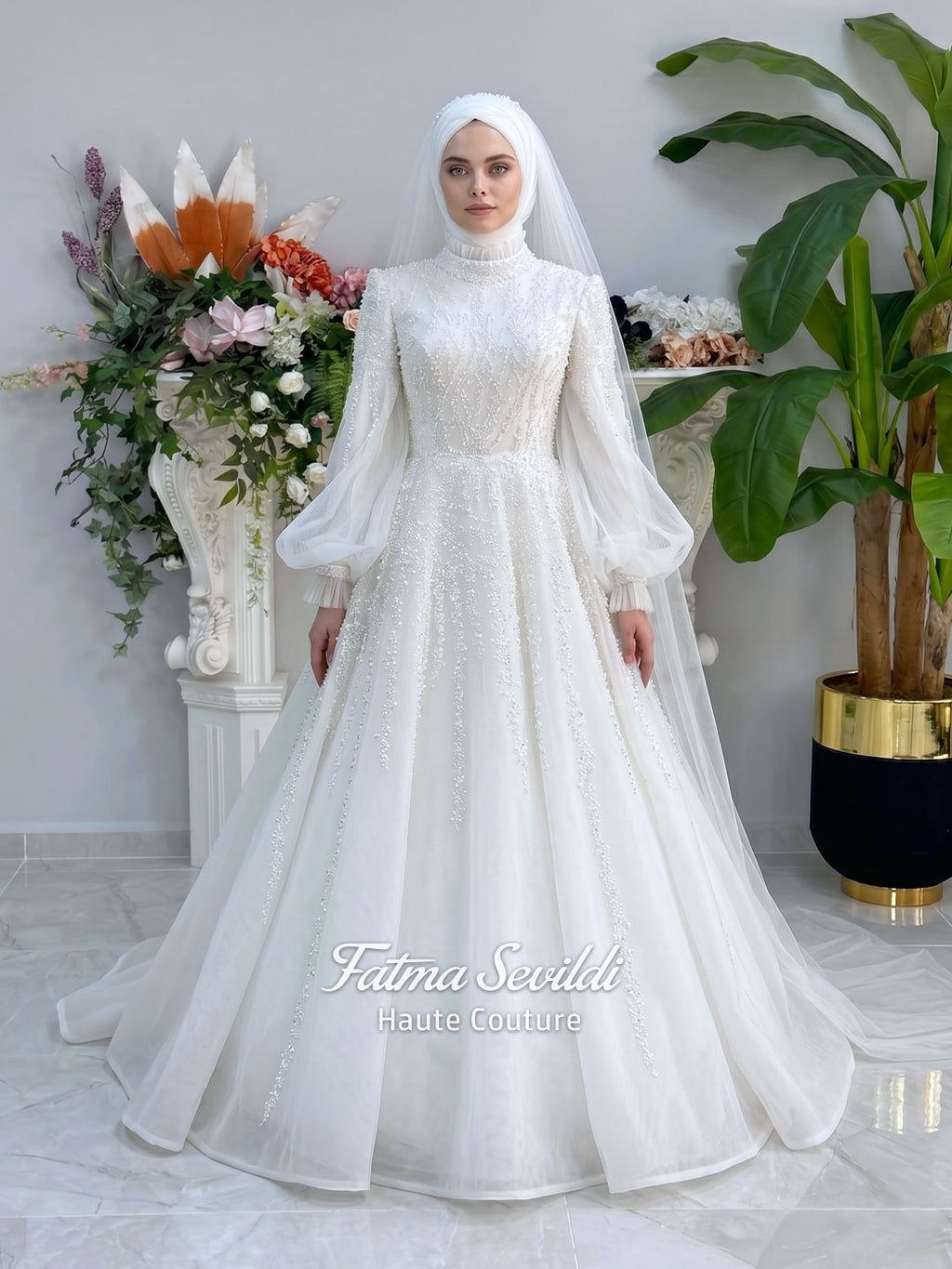Luxury hijab wedding dress in an A-line tulle ball gown silhouette with long balloon sleeves, high neck, sparkling beadwork, and a lace-edged veil.