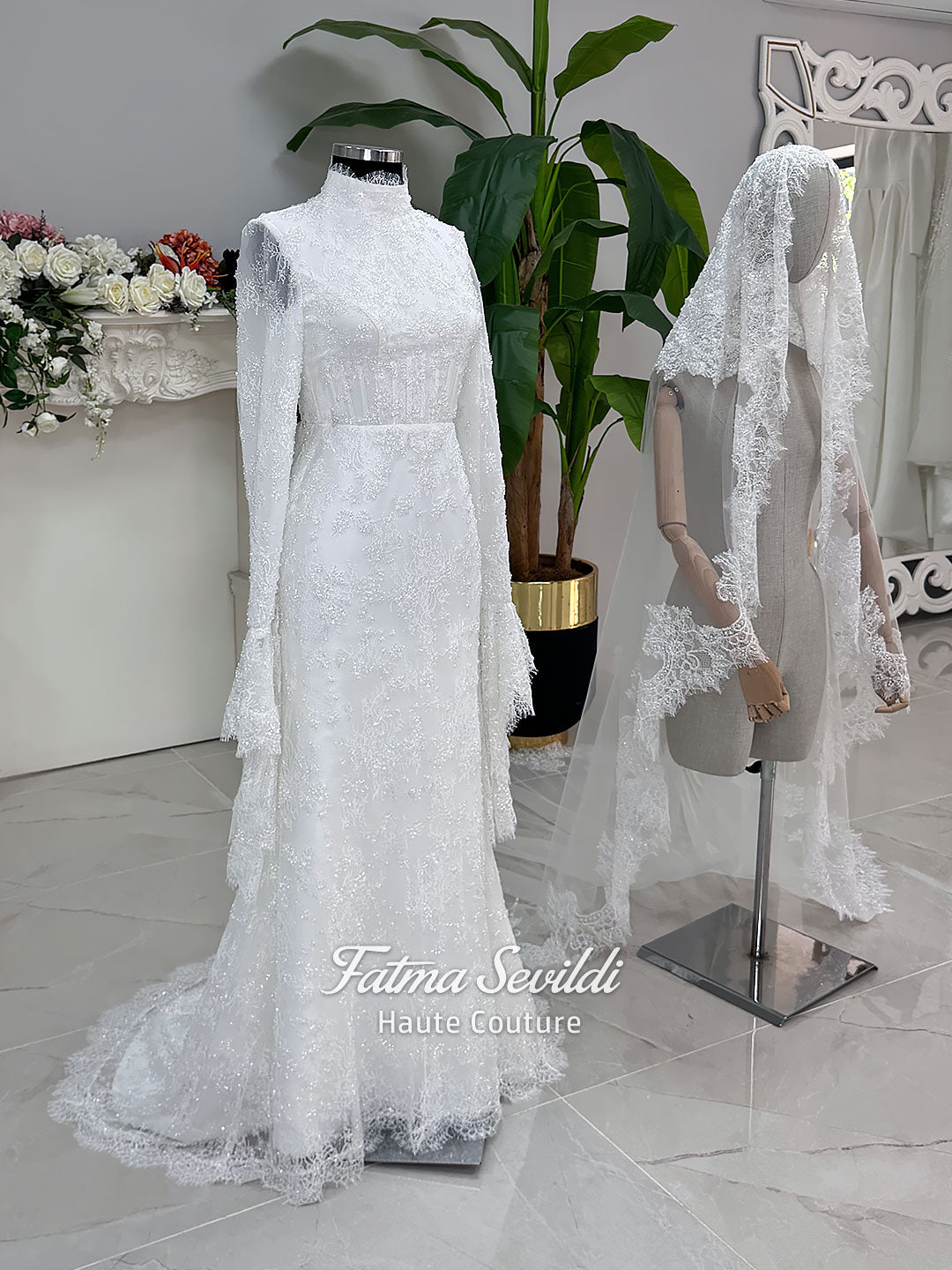Luxury hijab wedding dress with long flounce sleeves, a high mock neckline, beaded floral lace, corset fit, mermaid silhouette, detachable overskirt, and included lace veil. Modest Muslim bridal gown shown from front, back, and detail views.