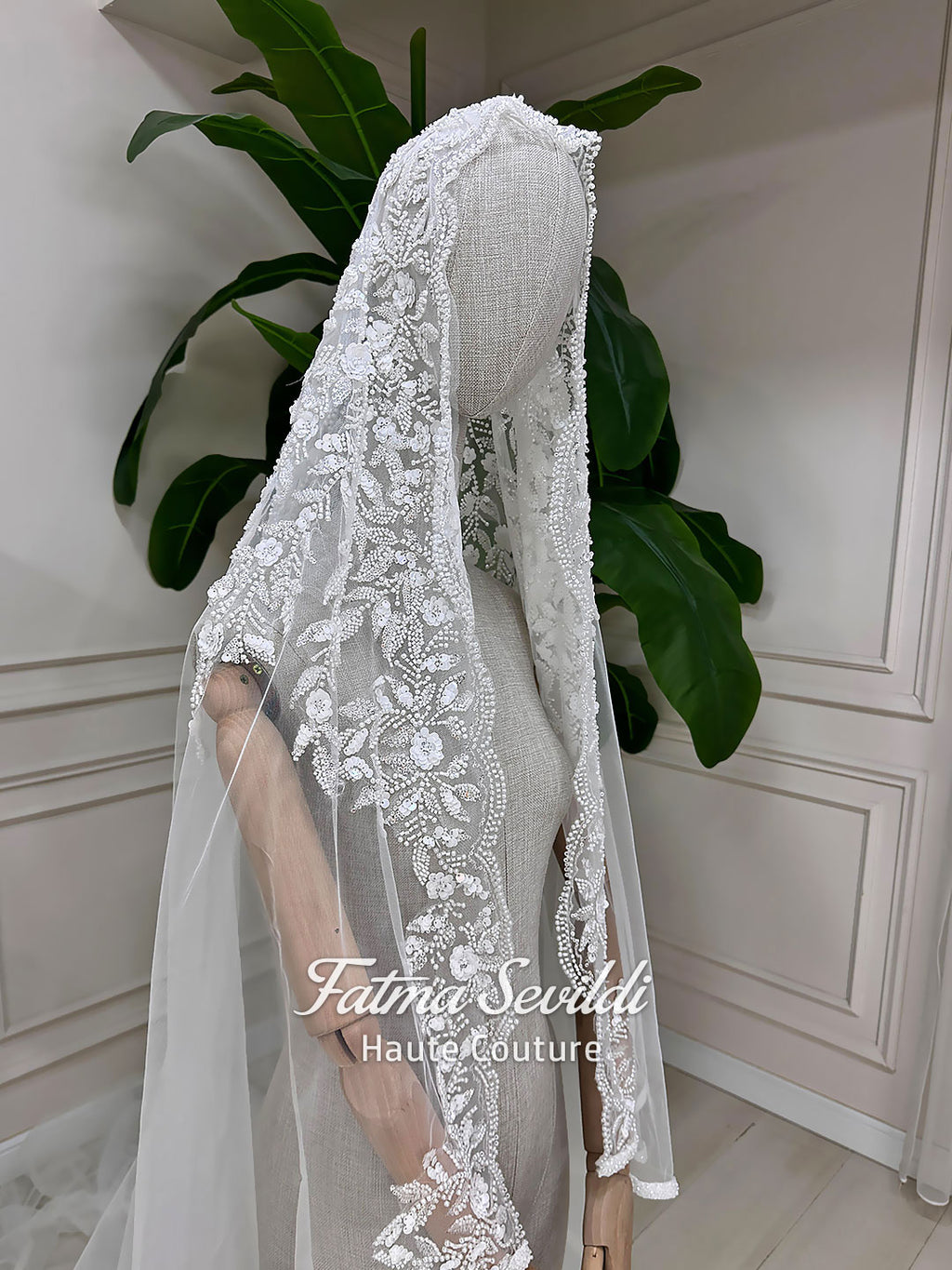 Luxury Muslim wedding dress with high neck, long sleeves, beaded lace embroidery, full A-line skirt, and matching premium lace veil. Elegant modest bridal gown custom made for hijab brides seeking a couture wedding look.