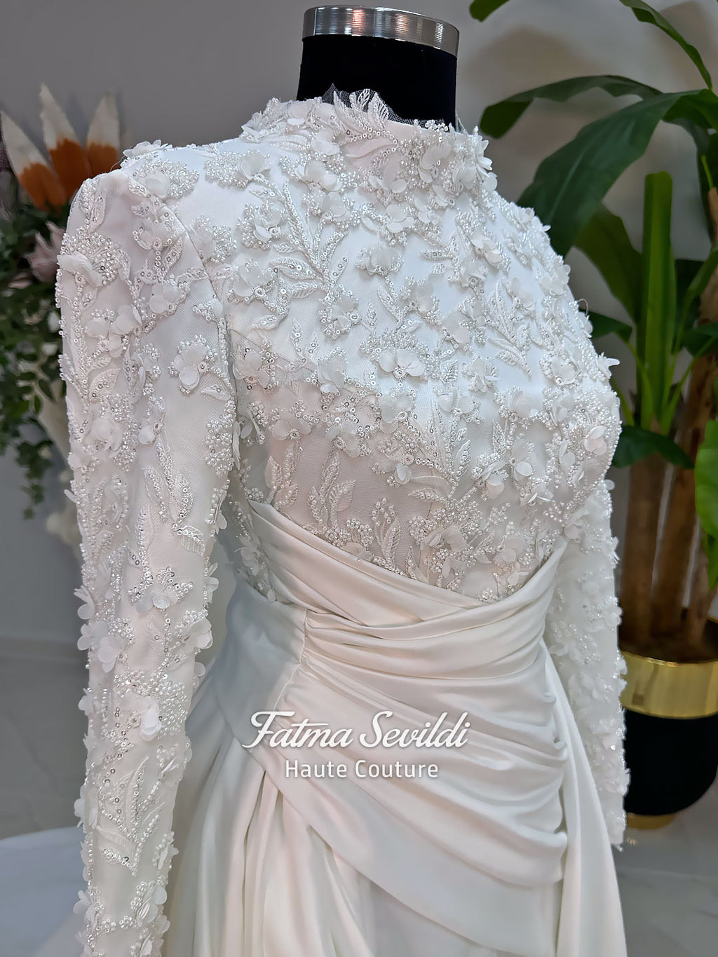 Luxury modest hijab wedding dress with long sleeves, 3D floral beaded lace bodice, draped satin A-line skirt and lace-edged veil included, shown on mannequin. Custom made Islamic bridal gown with elegant full coverage.