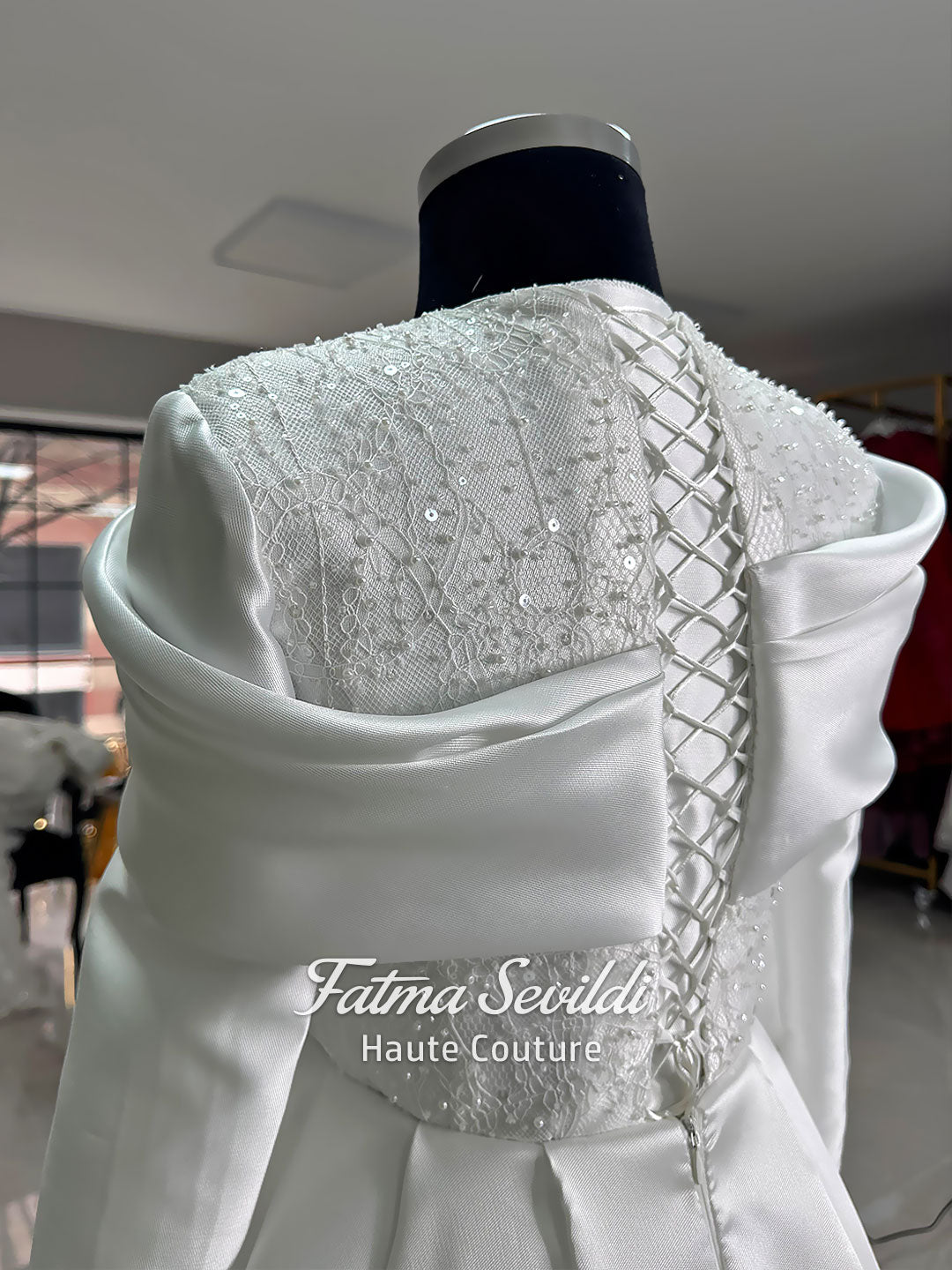 Luxury satin hijab wedding dress with off-shoulder long sleeves and an A-line silhouette, shown with premium lace veil and dramatic train. Custom couture modest bridal gown design with elegant draping and pearl details.