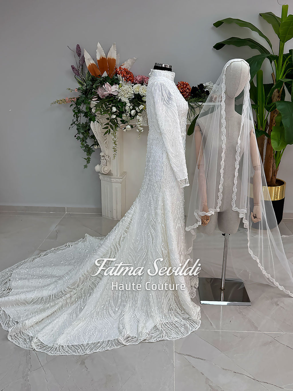Luxury hijab wedding dress with long sleeves, high neck, beaded lace mermaid silhouette and detachable overskirt, veiled bridal set. Handmade couture modest bridal gown with lace-up corset back and sparkling embroidery.