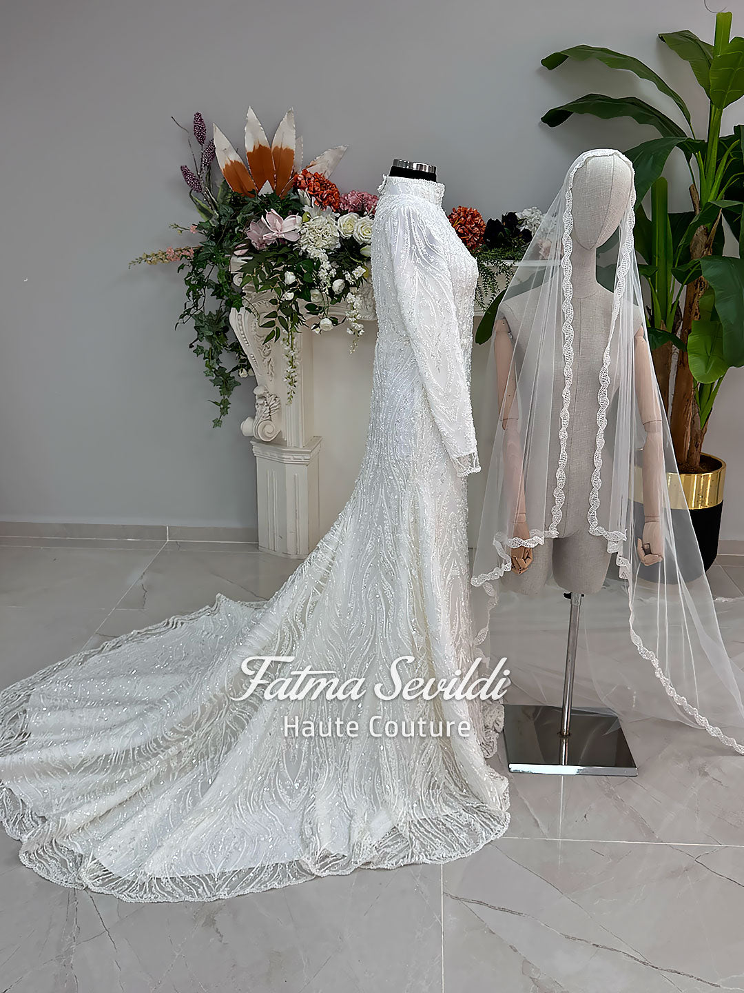 Luxury hijab wedding dress with long sleeves, high neck, beaded lace mermaid silhouette and detachable overskirt, veiled bridal set. Handmade couture modest bridal gown with lace-up corset back and sparkling embroidery.