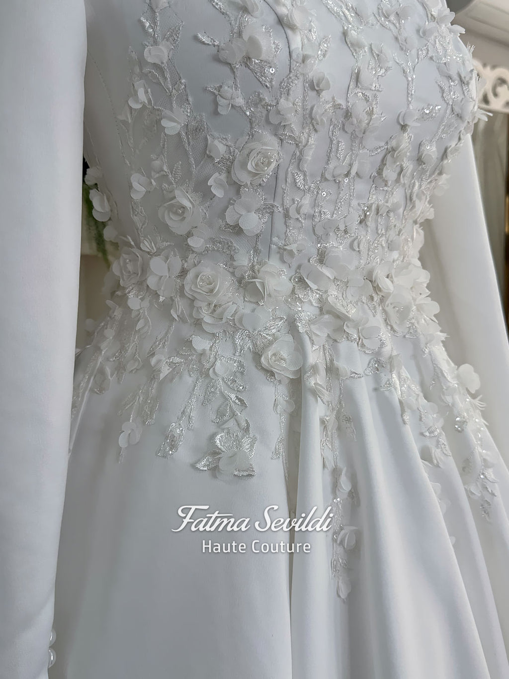 White A-line satin hijab wedding dress with long sleeves, high neckline, floral appliqué embroidery and an included premium lace mantilla veil for a modest Muslim bridal look.