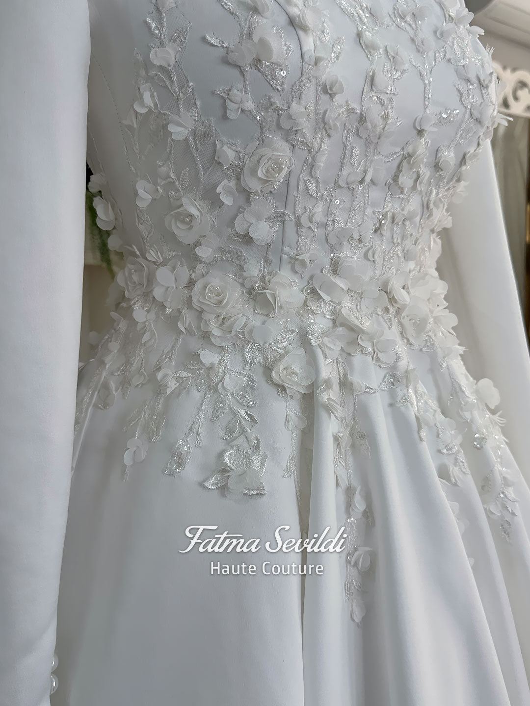 White A-line satin hijab wedding dress with long sleeves, high neckline, floral appliqué embroidery and an included premium lace mantilla veil for a modest Muslim bridal look.