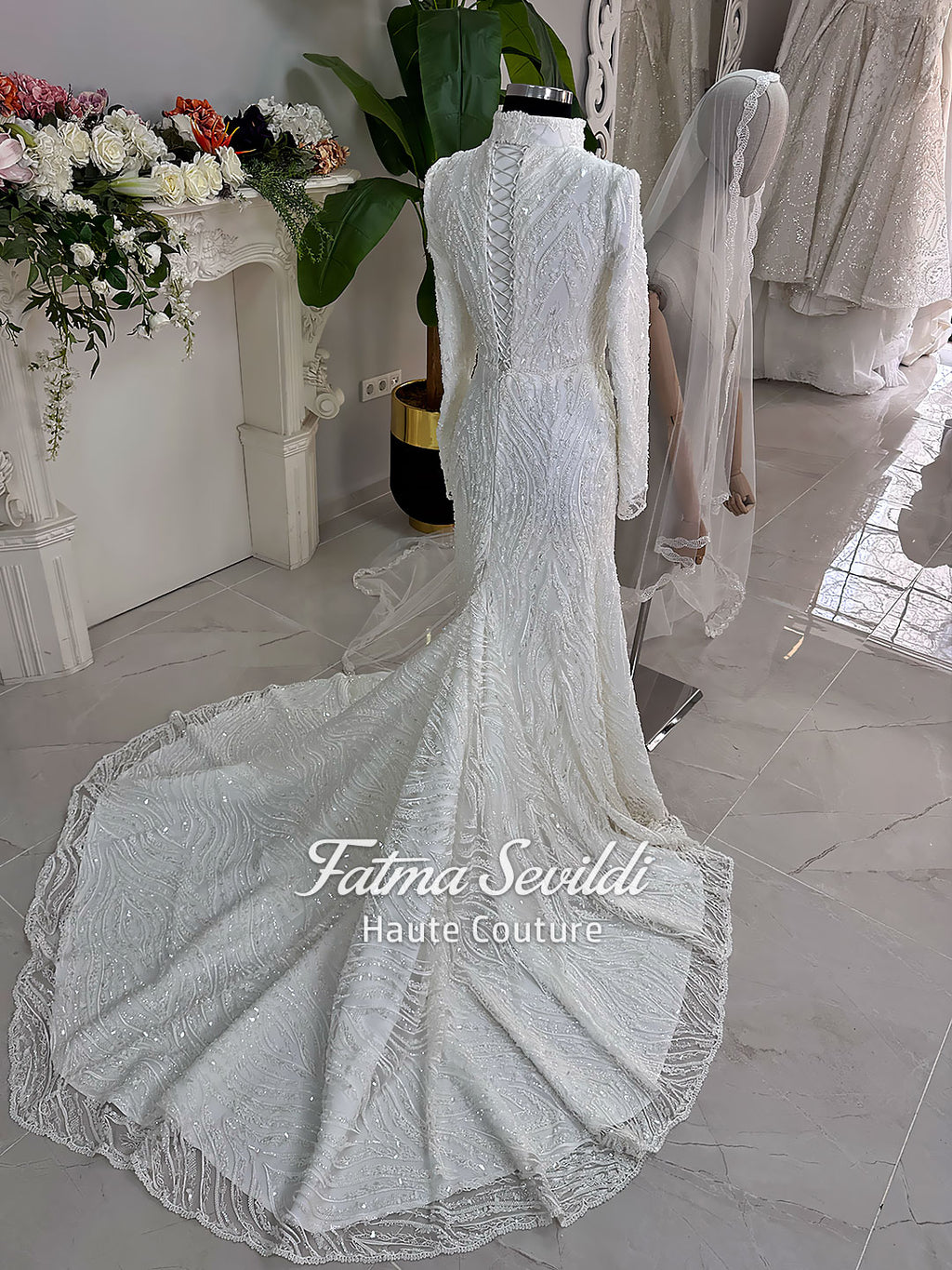 Luxury hijab wedding dress with long sleeves, high neck, beaded lace mermaid silhouette and detachable overskirt, veiled bridal set. Handmade couture modest bridal gown with lace-up corset back and sparkling embroidery.