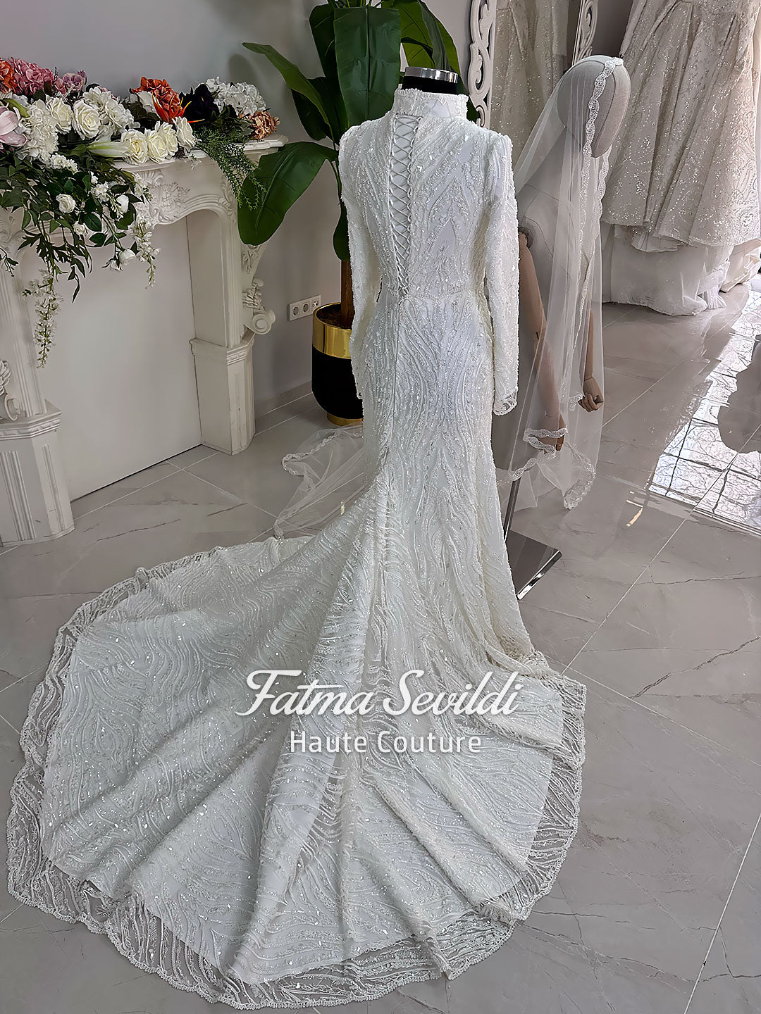 Luxury hijab wedding dress with long sleeves, high neck, beaded lace mermaid silhouette and detachable overskirt, veiled bridal set. Handmade couture modest bridal gown with lace-up corset back and sparkling embroidery.