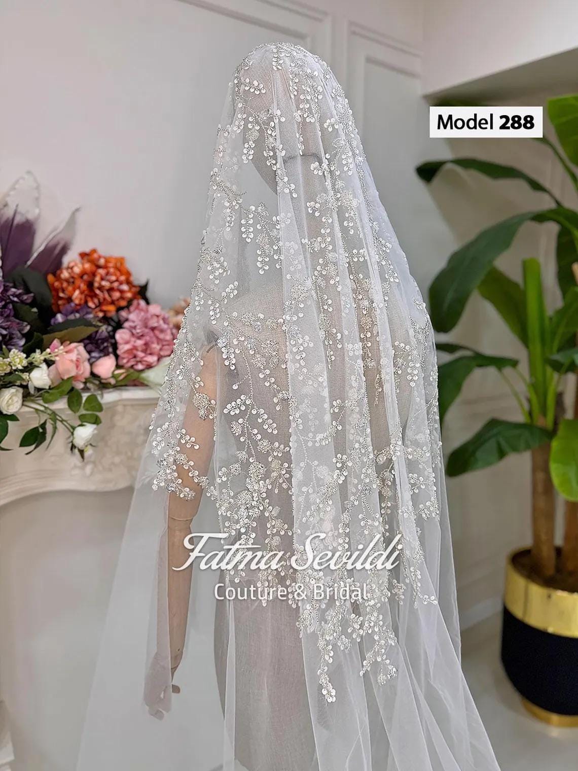 Delicate beaded lace cathedral bridal veil with hand-sewn floral applique