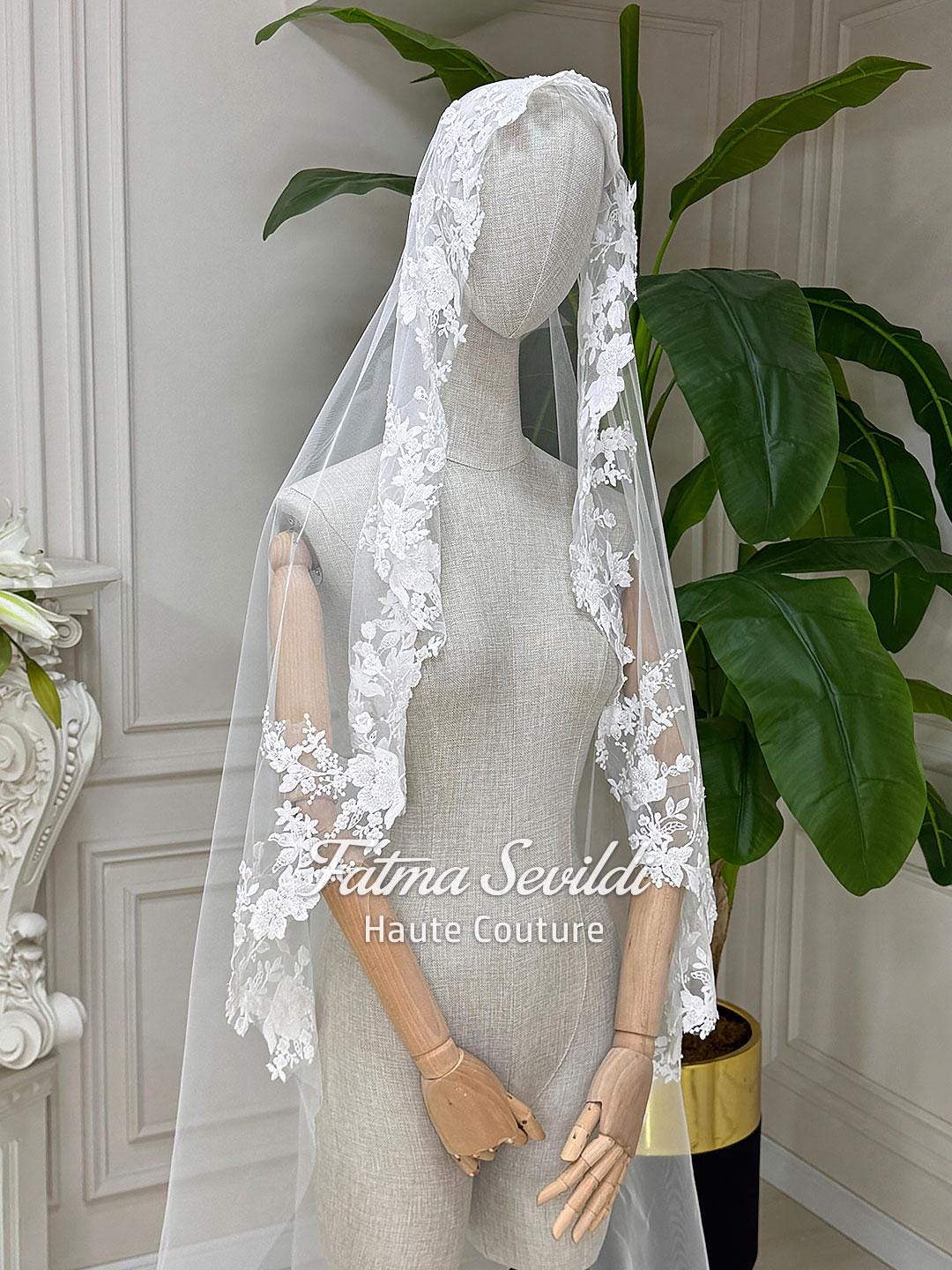 Elegant veiled hijab wedding gown with white lace veil, floral embroidery, beaded long sleeve high neck A-line design