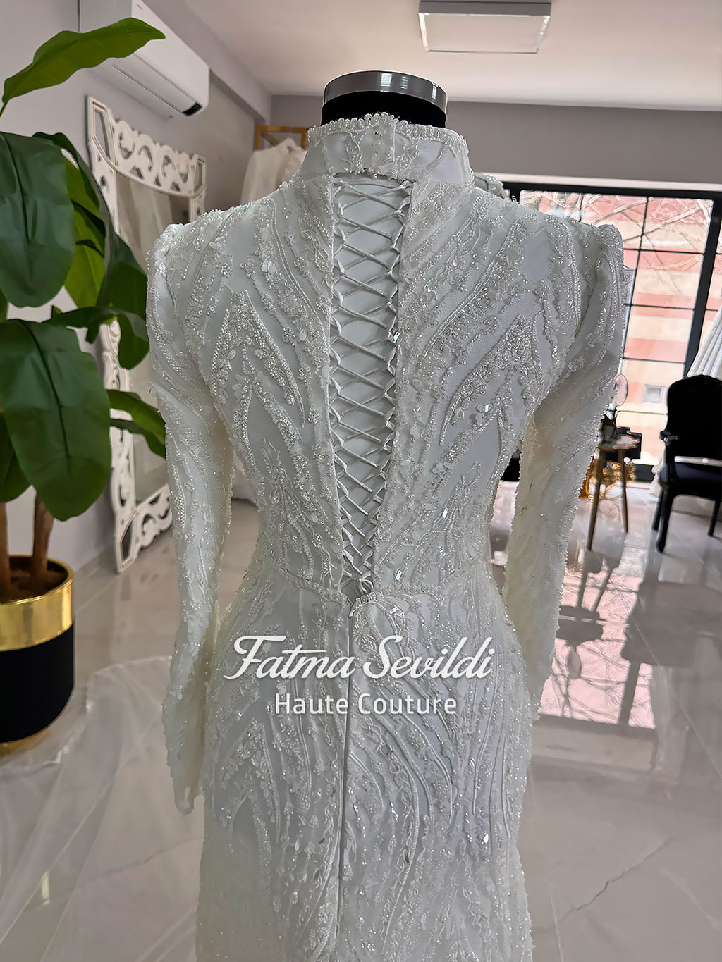 Luxury hijab wedding dress with long sleeves, high neck, beaded lace mermaid silhouette and detachable overskirt, veiled bridal set. Handmade couture modest bridal gown with lace-up corset back and sparkling embroidery.