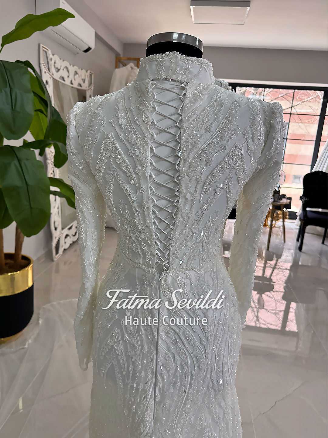 Luxury hijab wedding dress with long sleeves, high neck, beaded lace mermaid silhouette and detachable overskirt, veiled bridal set. Handmade couture modest bridal gown with lace-up corset back and sparkling embroidery.
