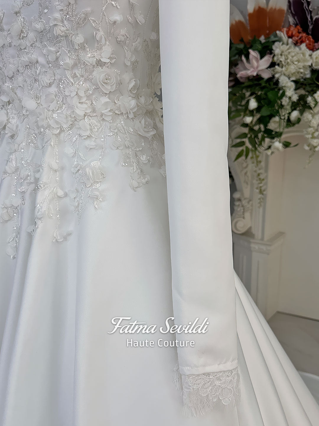 White A-line satin hijab wedding dress with long sleeves, high neckline, floral appliqué embroidery and an included premium lace mantilla veil for a modest Muslim bridal look.