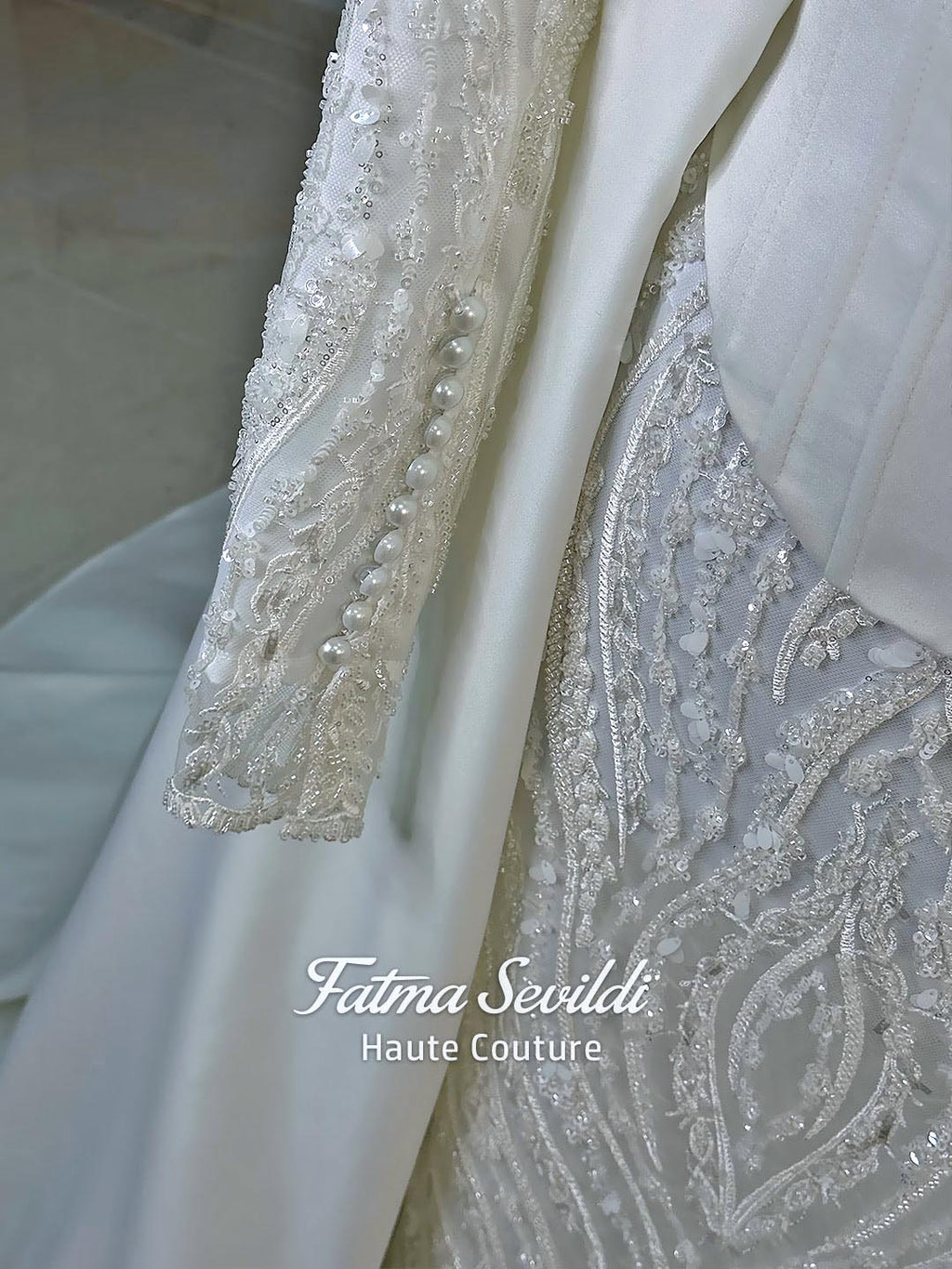 Luxury hijab wedding dress with long sleeves, high neck, beaded lace mermaid silhouette and detachable overskirt, veiled bridal set. Handmade couture modest bridal gown with lace-up corset back and sparkling embroidery.