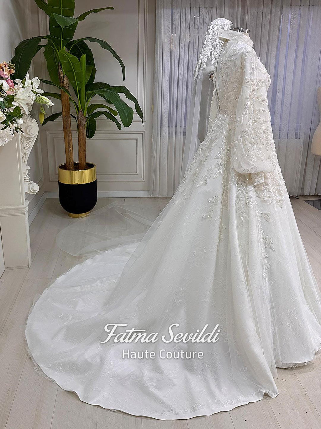 Elegant veiled hijab bridal gown with lace, beads, and long train