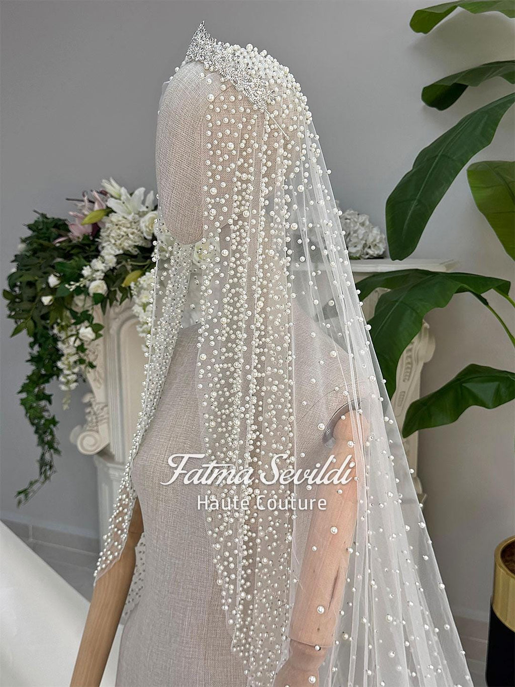 Delicate white beaded veil with sparkling tiara on veiled hijab wedding gown