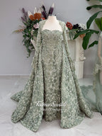 Sage green evening dress with beaded floral lace, a sweetheart neckline and long sleeves with flared lace cuffs, displayed on a mannequin.