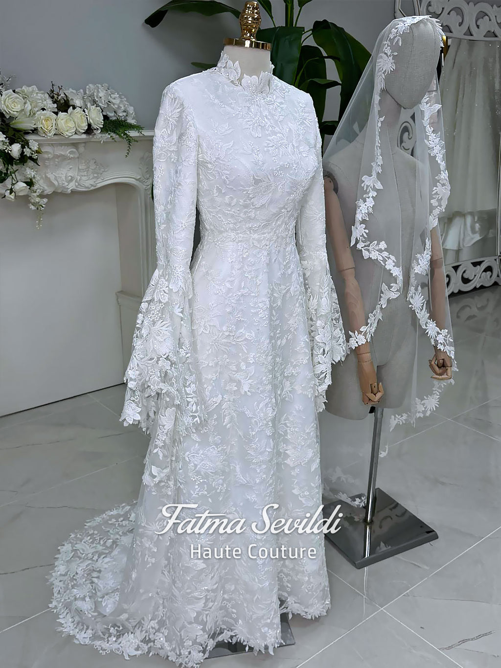 Veiled hijab wedding dress with high neck, long sleeves, and beaded floral lace in an elegant A-line couture silhouette.