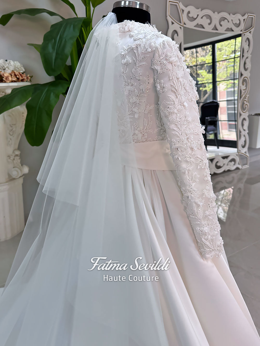 Luxury modest hijab wedding dress with long sleeves, 3D floral beaded lace bodice, draped satin A-line skirt and lace-edged veil included, shown on mannequin. Custom made Islamic bridal gown with elegant full coverage.