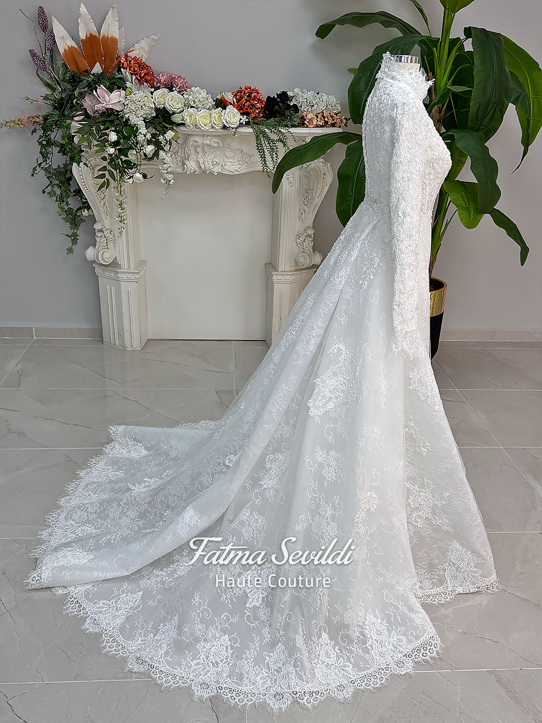 Luxury hijab wedding dress with long sleeves, high mock neck, floral lace embroidery, detachable mermaid skirt, dramatic train and premium lace veil for a modest Muslim bride.