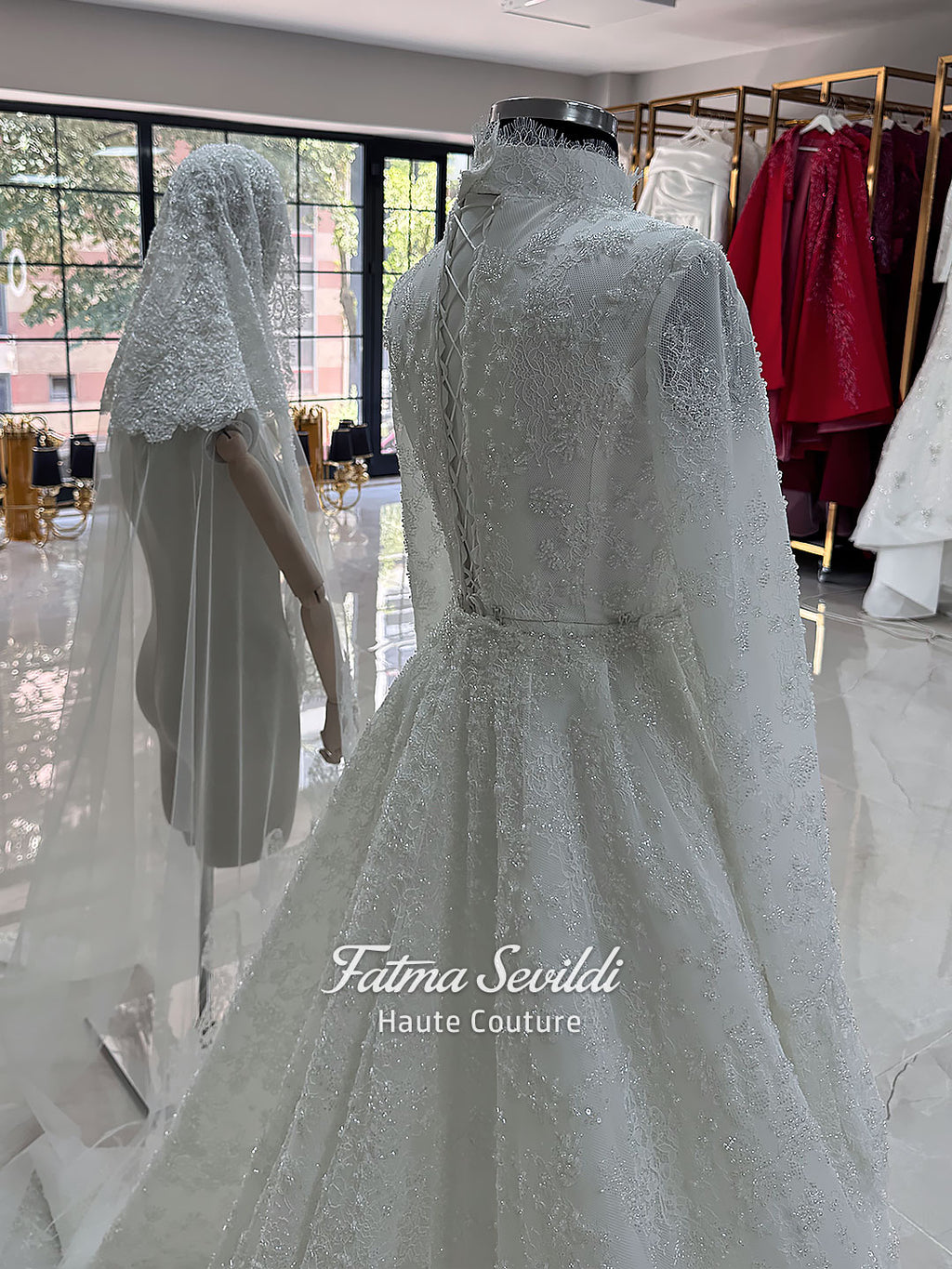 Luxury hijab wedding dress with long flounce sleeves, a high mock neckline, beaded floral lace, corset fit, mermaid silhouette, detachable overskirt, and included lace veil. Modest Muslim bridal gown shown from front, back, and detail views.