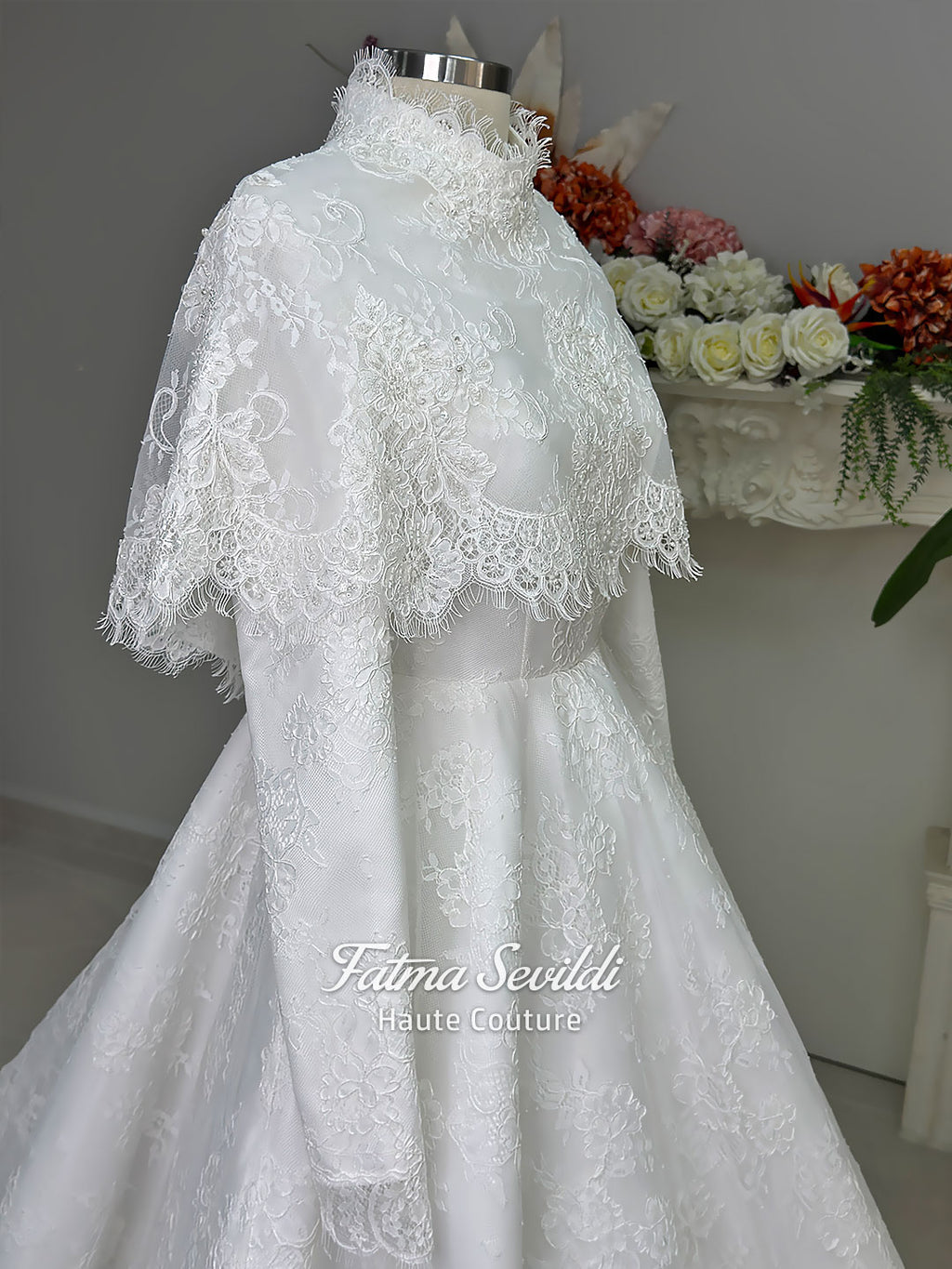 Elegant hijab wedding dress with long sleeves, high neck, detachable lace cape, cathedral train, and premium lace veil included. Luxury modest bridal couture gown in white with floral lace detailing.