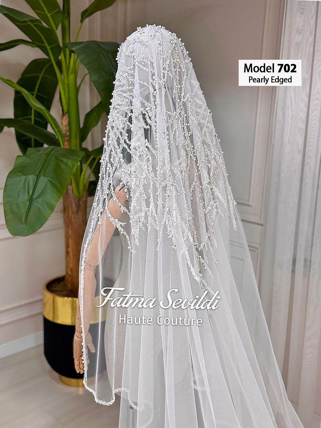 Delicate pearl-edged white bridal veil by Fatma Sevildi, hand-sewn beaded lace