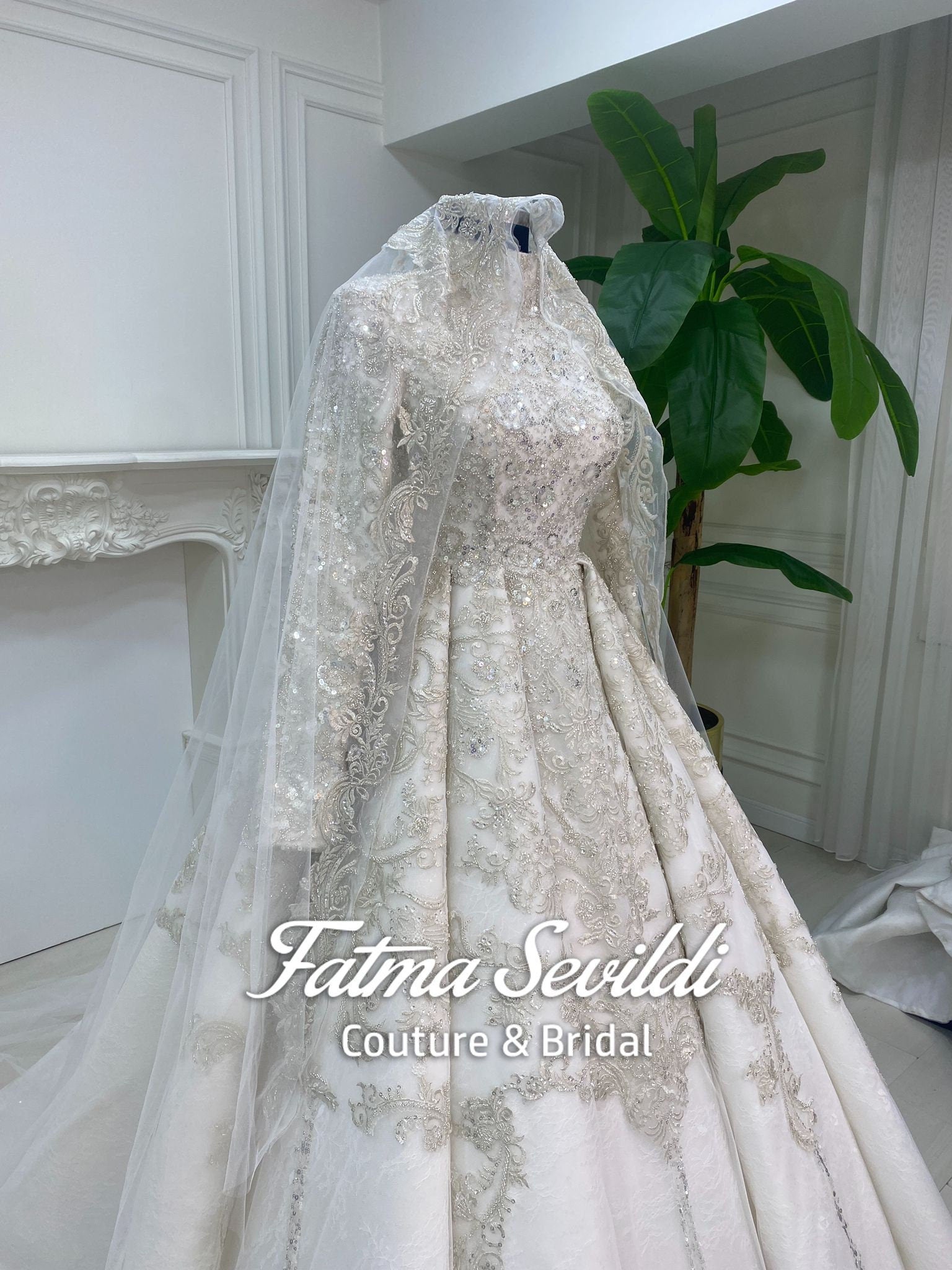 Elegant beaded lace hijab wedding dress with long sleeves and A-line skirt