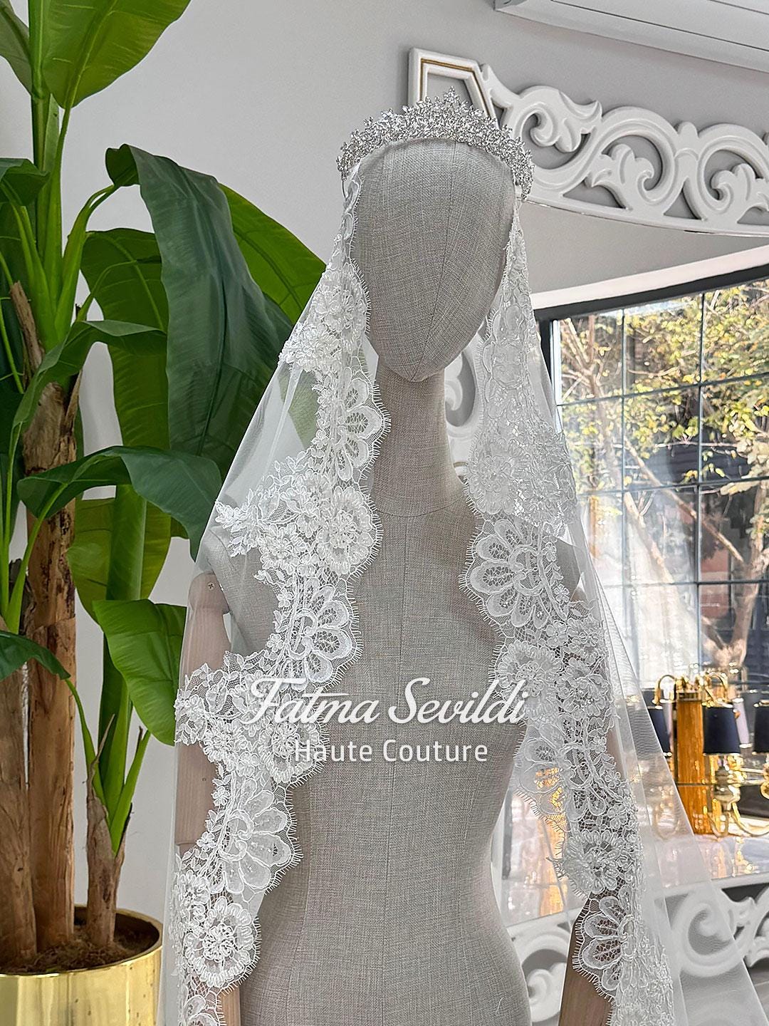 Elegant white lace bridal veil with floral embroidery and beaded headpiece