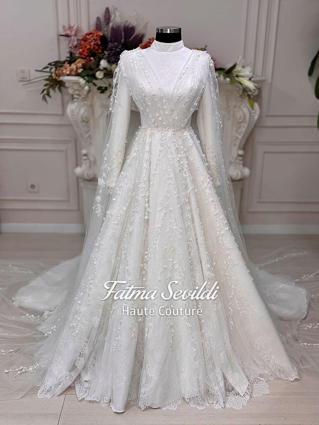 Elegant white floral lace Muslim wedding gown by Fatma Sevildi, long sleeve A-line with veil