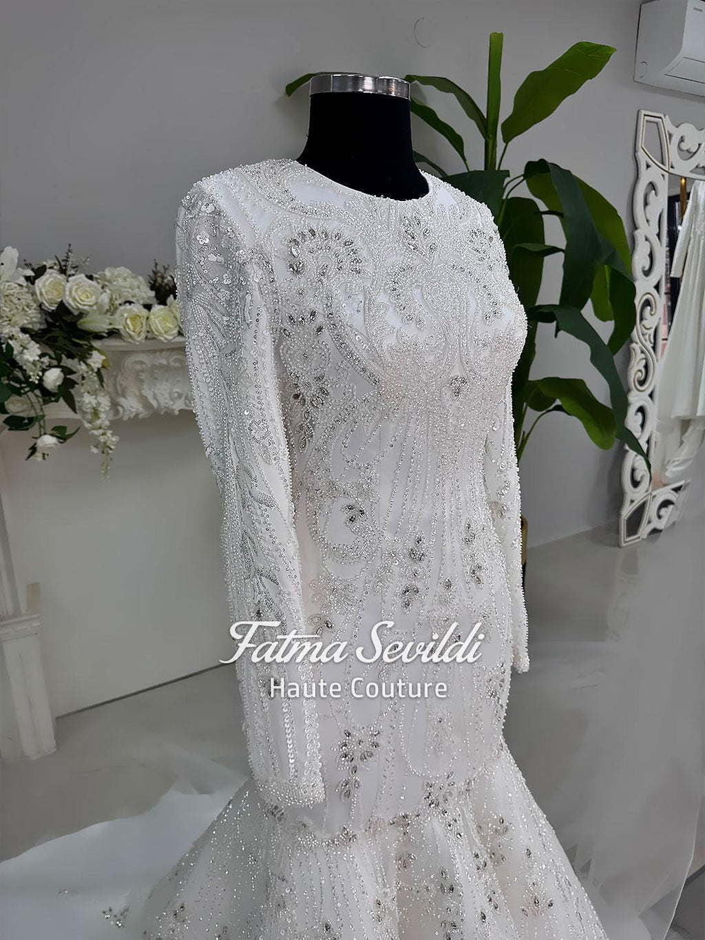 White beaded mermaid hijab wedding dress with long sleeves and silver embellishments