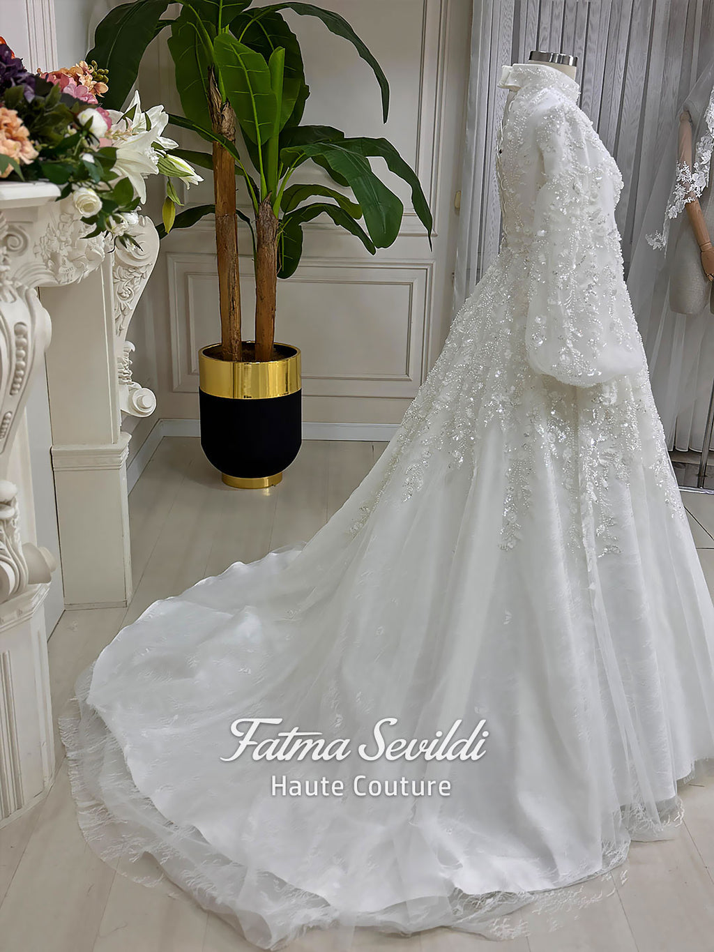 Luxury Muslim wedding dress with high neck, long sleeves, beaded lace embroidery, full A-line skirt, and matching premium lace veil. Elegant modest bridal gown custom made for hijab brides seeking a couture wedding look.