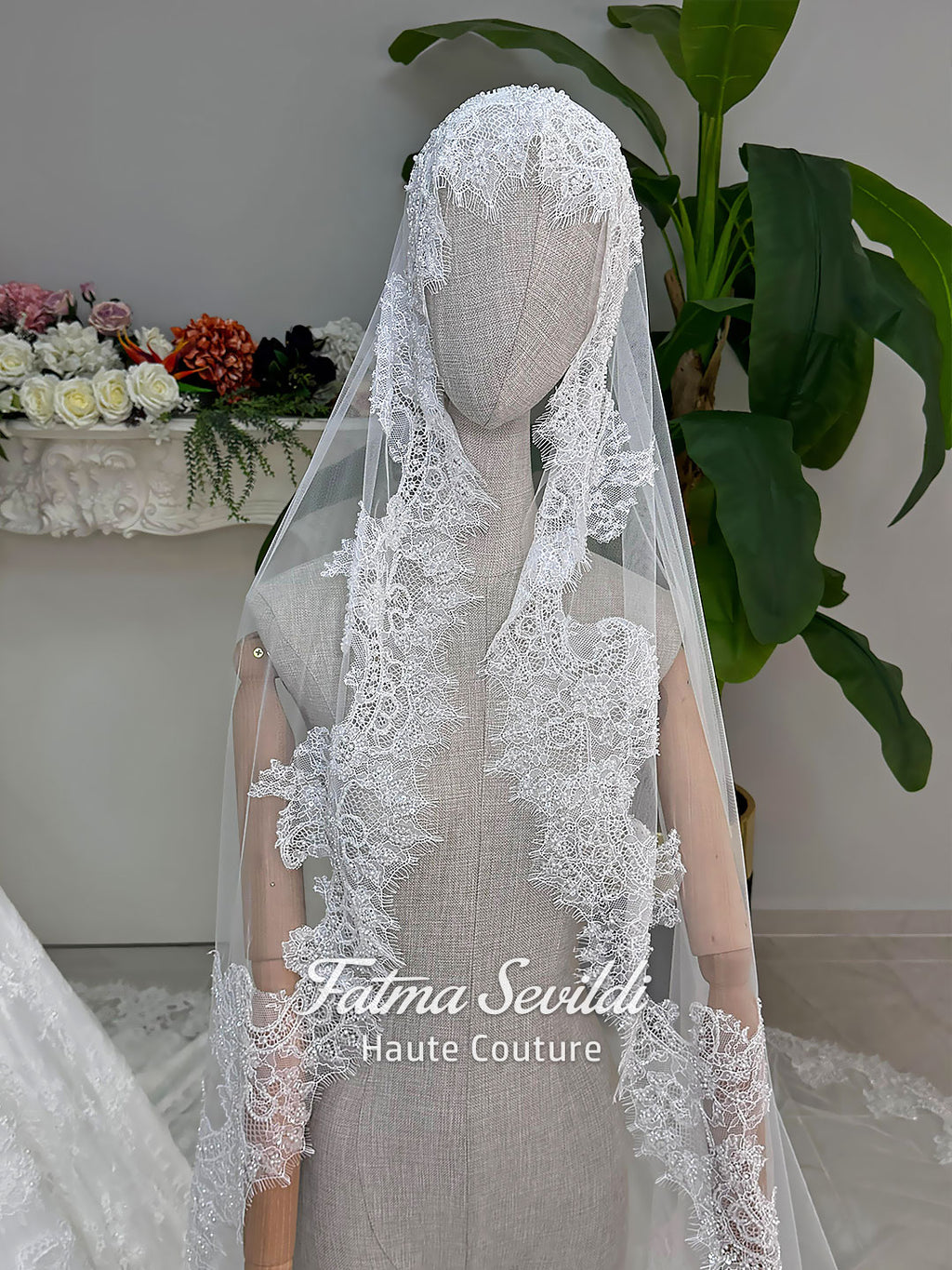 Luxury hijab wedding dress with long sleeves and high neckline, featuring beaded lace over a full ballgown silhouette and matching veiled bridal set. Couture modest bridal gown handmade in Türkiye.