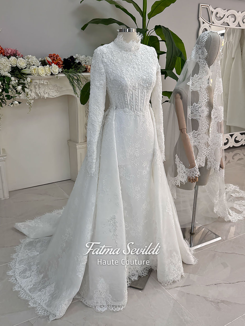 Luxury hijab wedding dress with long sleeves, high mock neck, floral lace embroidery, detachable mermaid skirt, dramatic train and premium lace veil for a modest Muslim bride.
