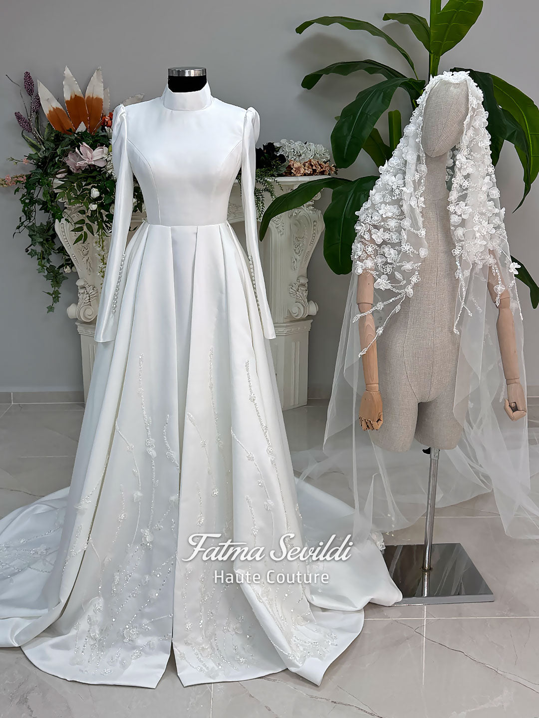 Luxury hijab wedding dress with long sleeves and high neck in an elegant A-line silhouette, shown with premium lace veil. Modest bridal gown featuring subtle sparkle embroidery and a chapel train.
