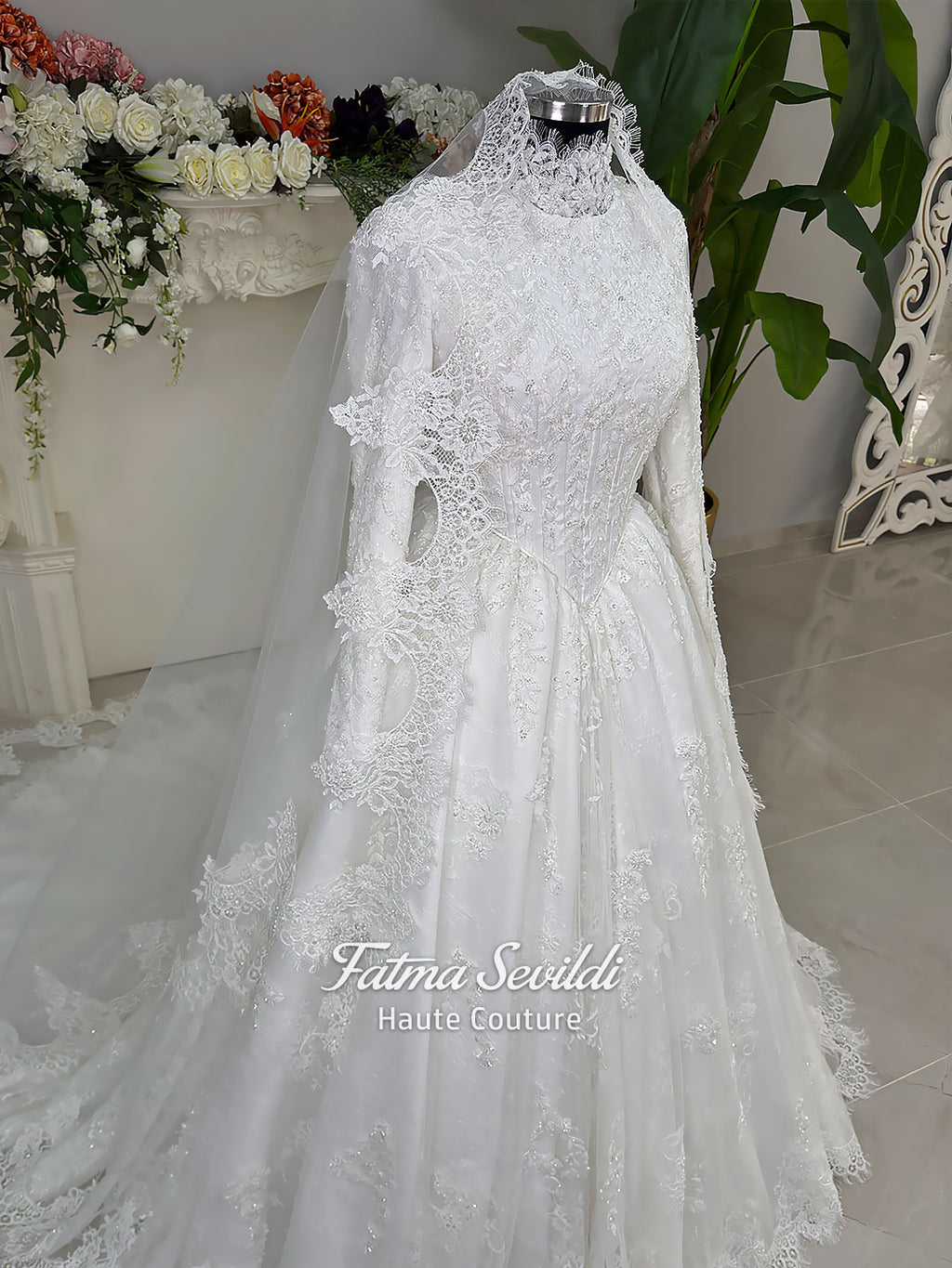 Luxury modest hijab wedding dress ball gown with long sleeves, high neck corset bodice, lace appliqué and included lace veil, photographed in a bridal atelier.