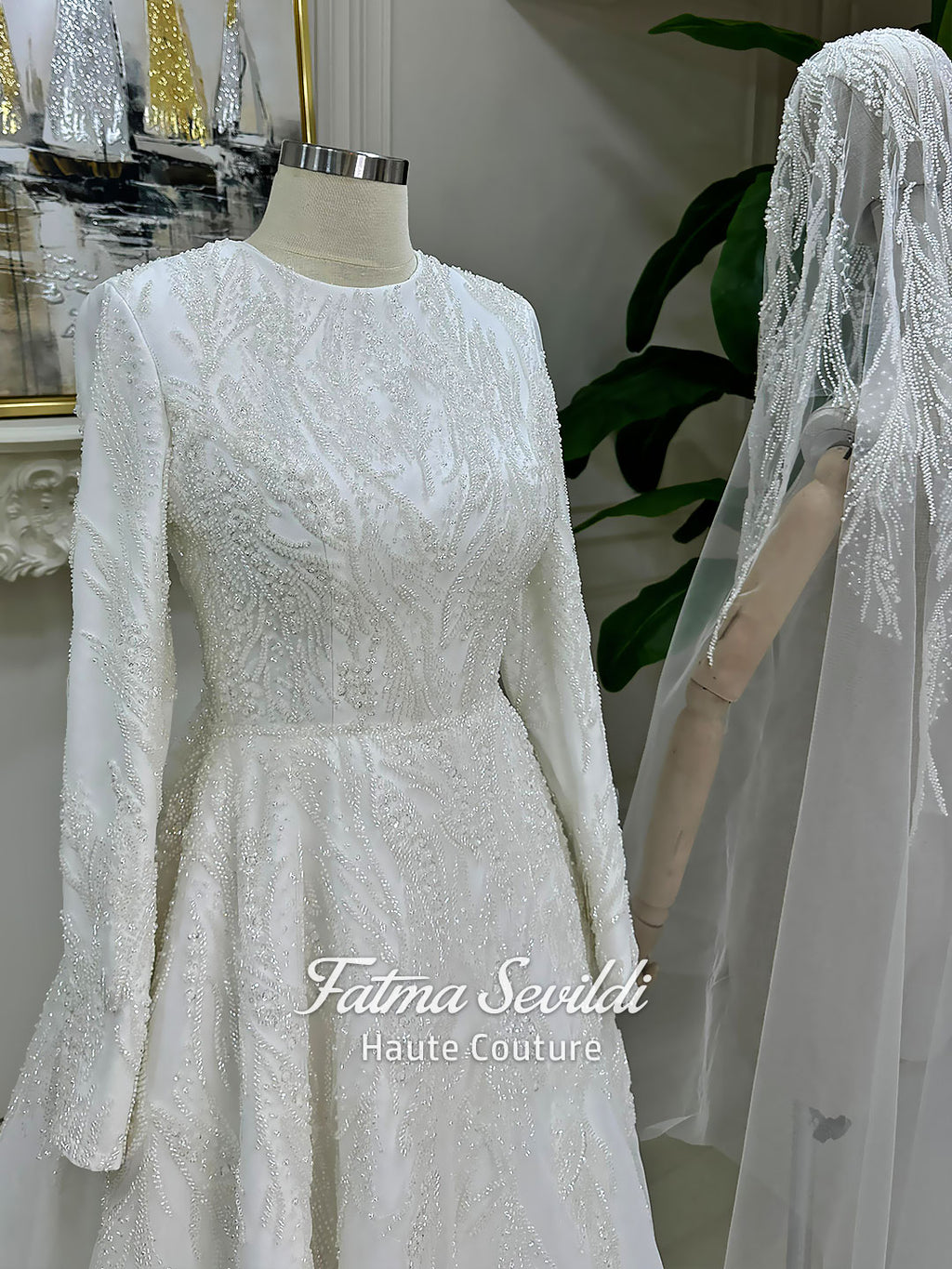 Luxury modest hijab wedding dress with long sleeves and A-line silhouette, fully beaded embroidery, shown with embellished lace cathedral veil.
