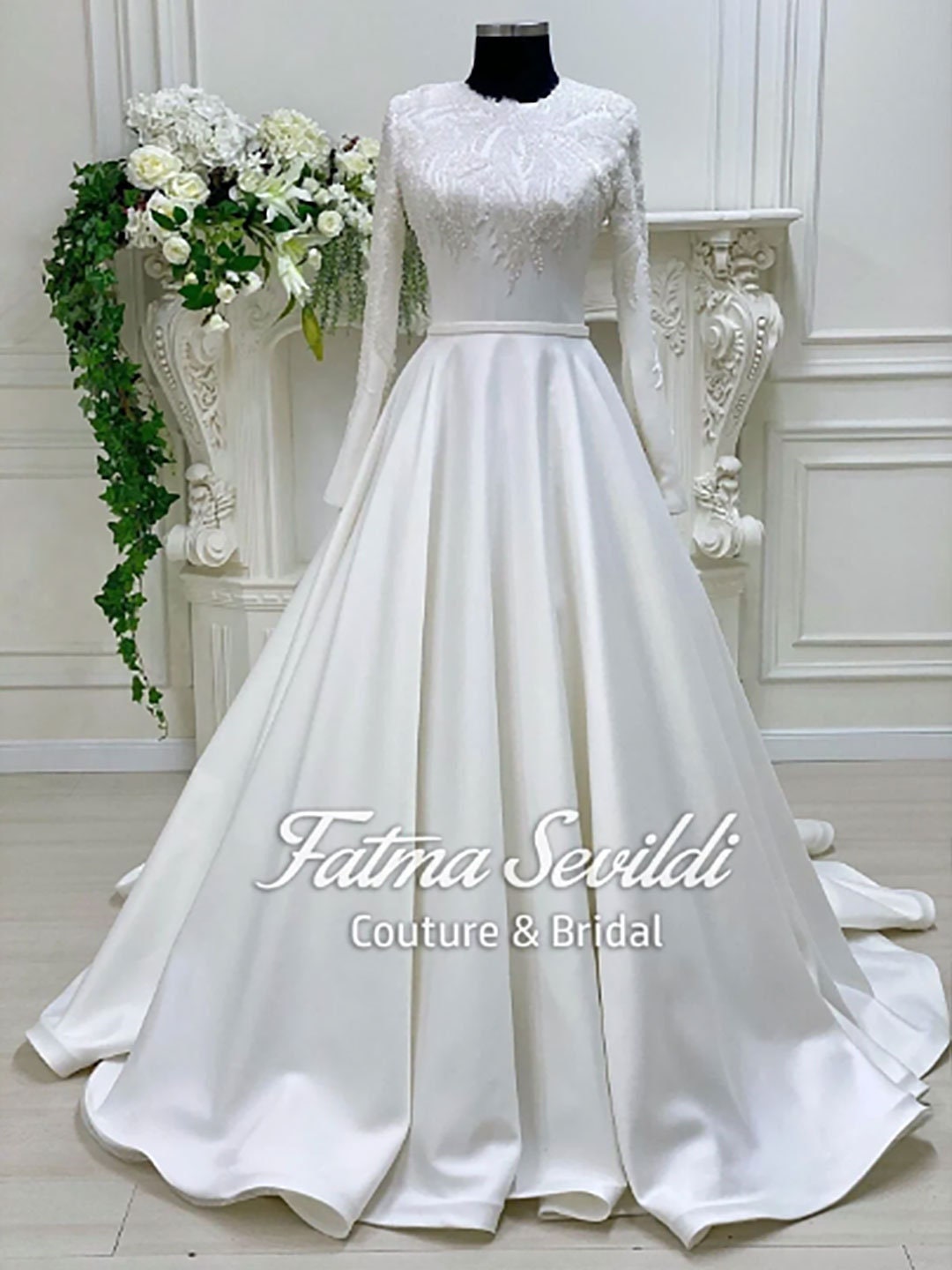 Elegant white satin A-line wedding gown with lace sleeves and veil