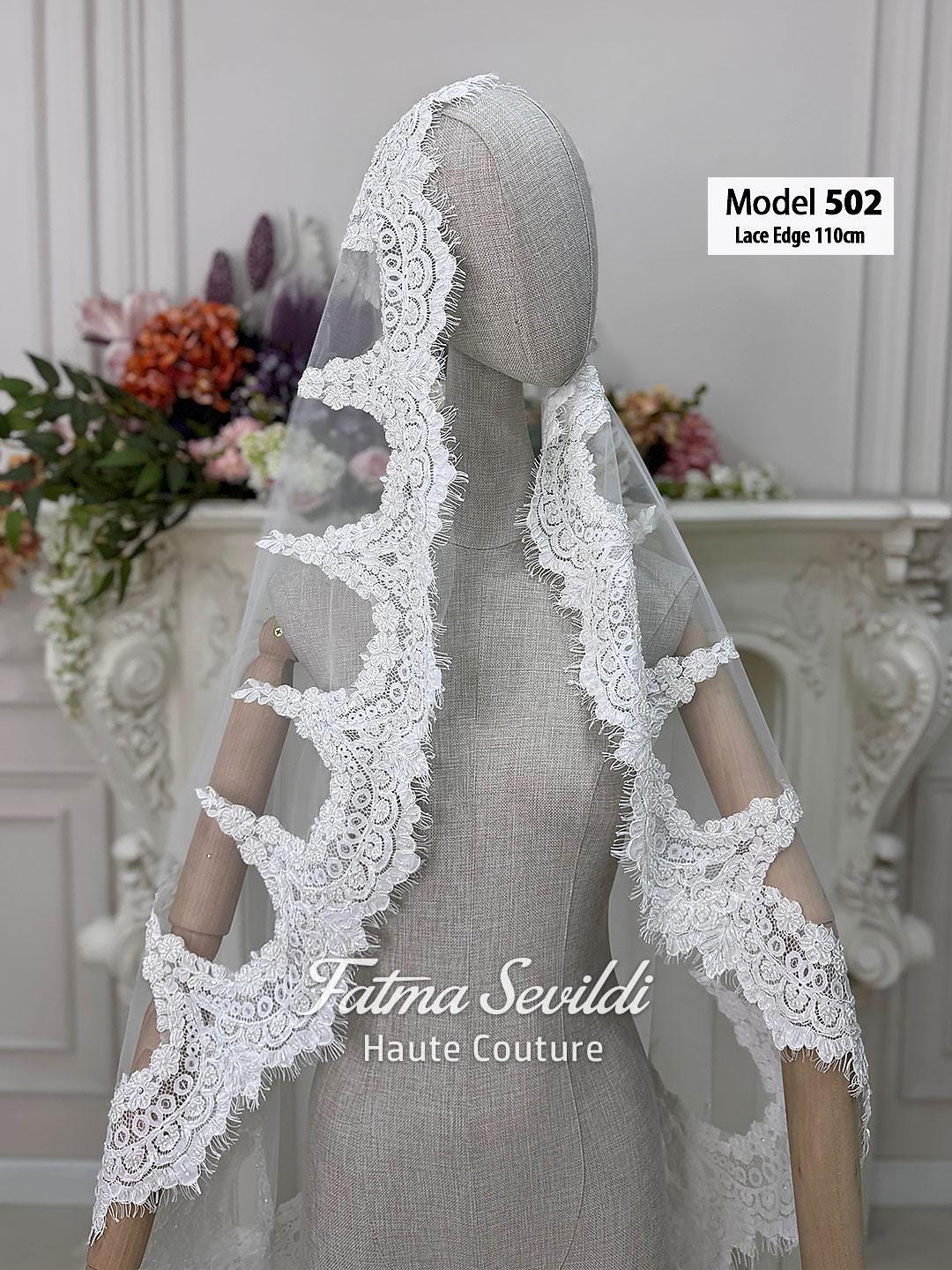 White lace-edged bridal veil with floral patterns and beaded applique