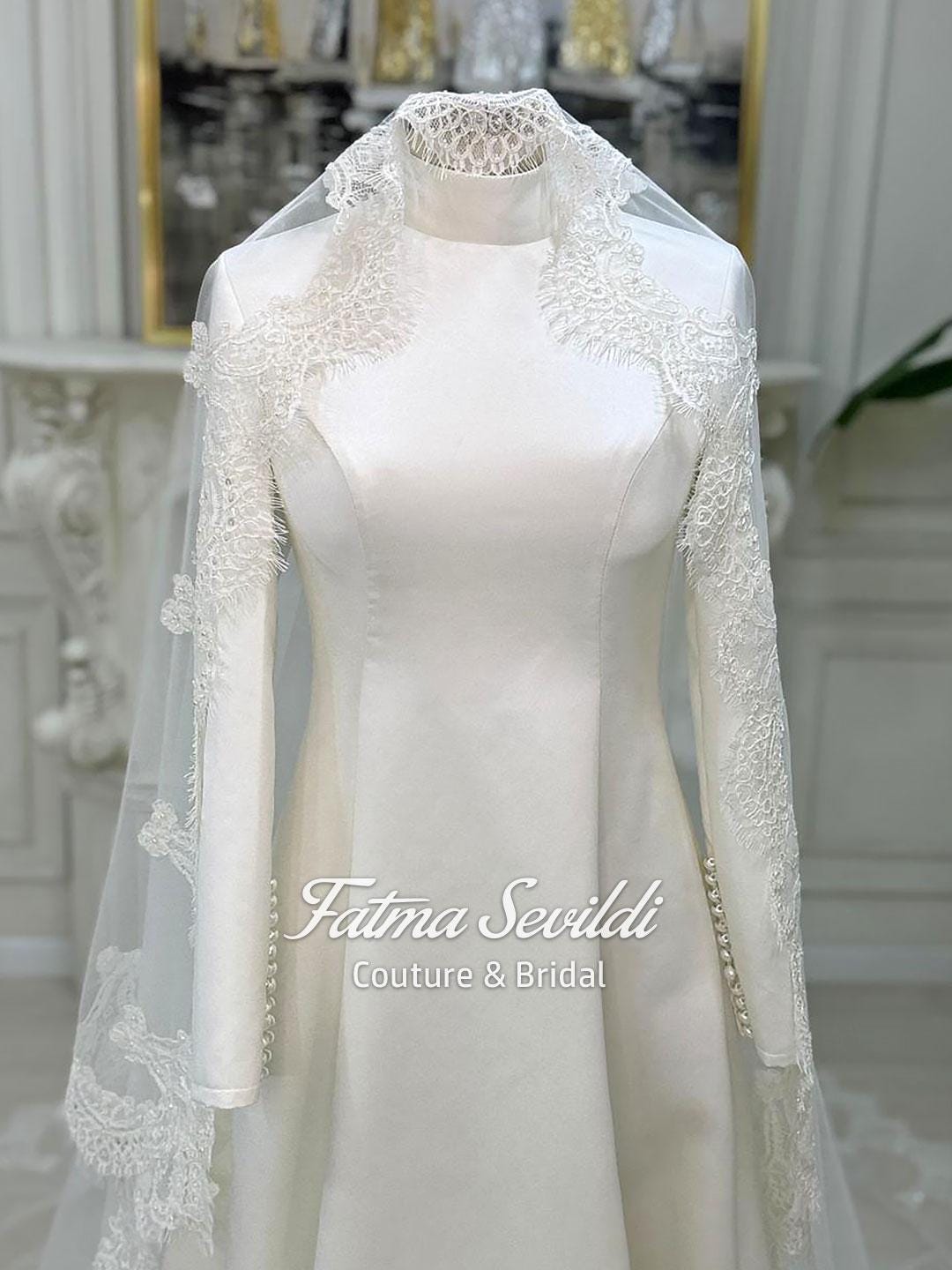 Elegant high neck satin A-line bridal gown with long lace sleeves and veiled hijab