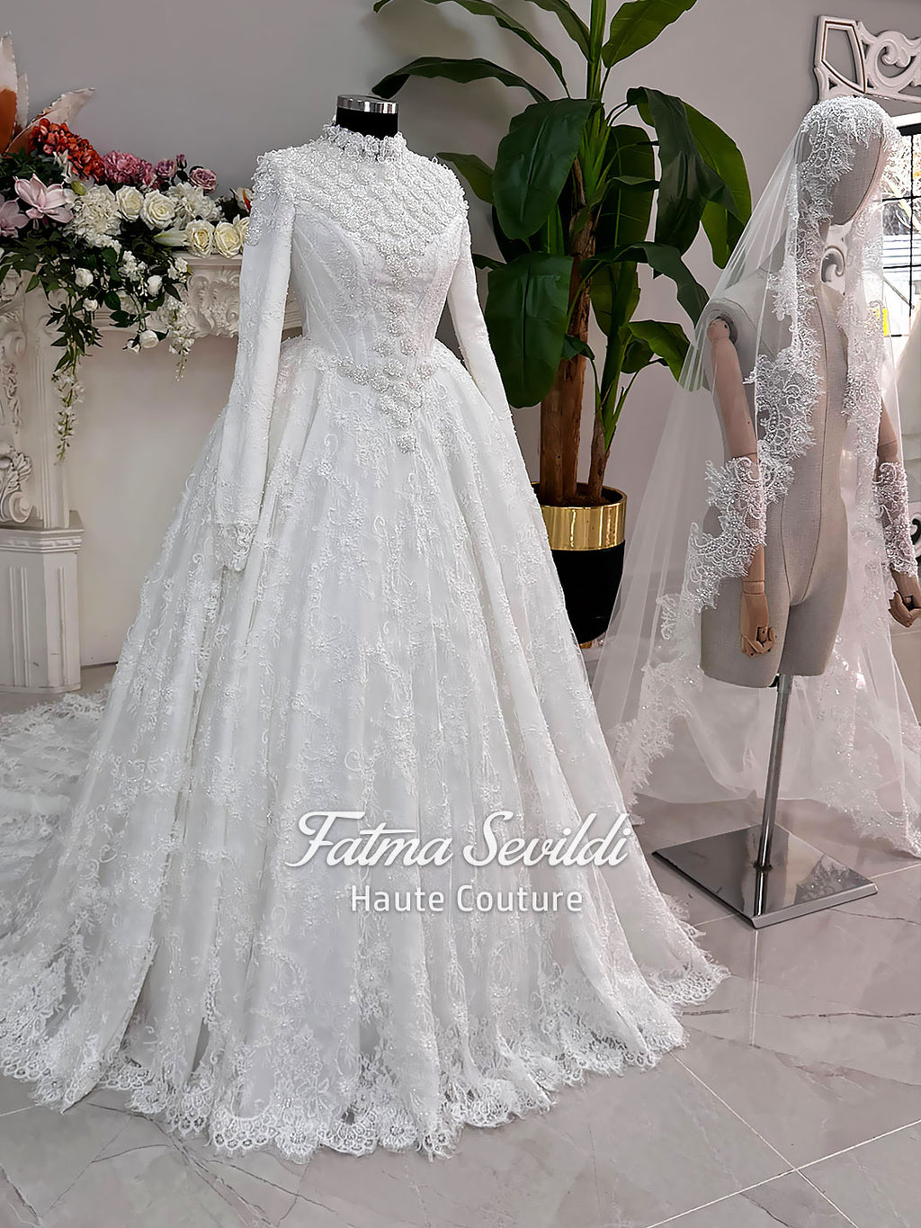 Luxury hijab wedding dress with long sleeves and high neckline, featuring beaded lace over a full ballgown silhouette and matching veiled bridal set. Couture modest bridal gown handmade in Türkiye.