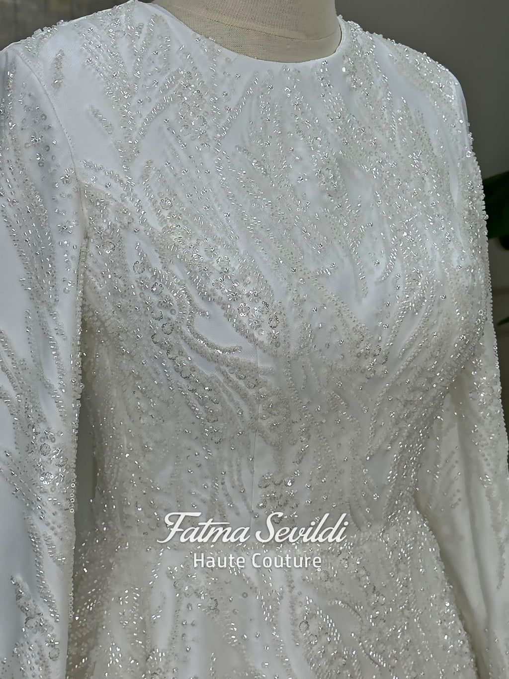 Luxury modest hijab wedding dress with long sleeves and A-line silhouette, fully beaded embroidery, shown with embellished lace cathedral veil.