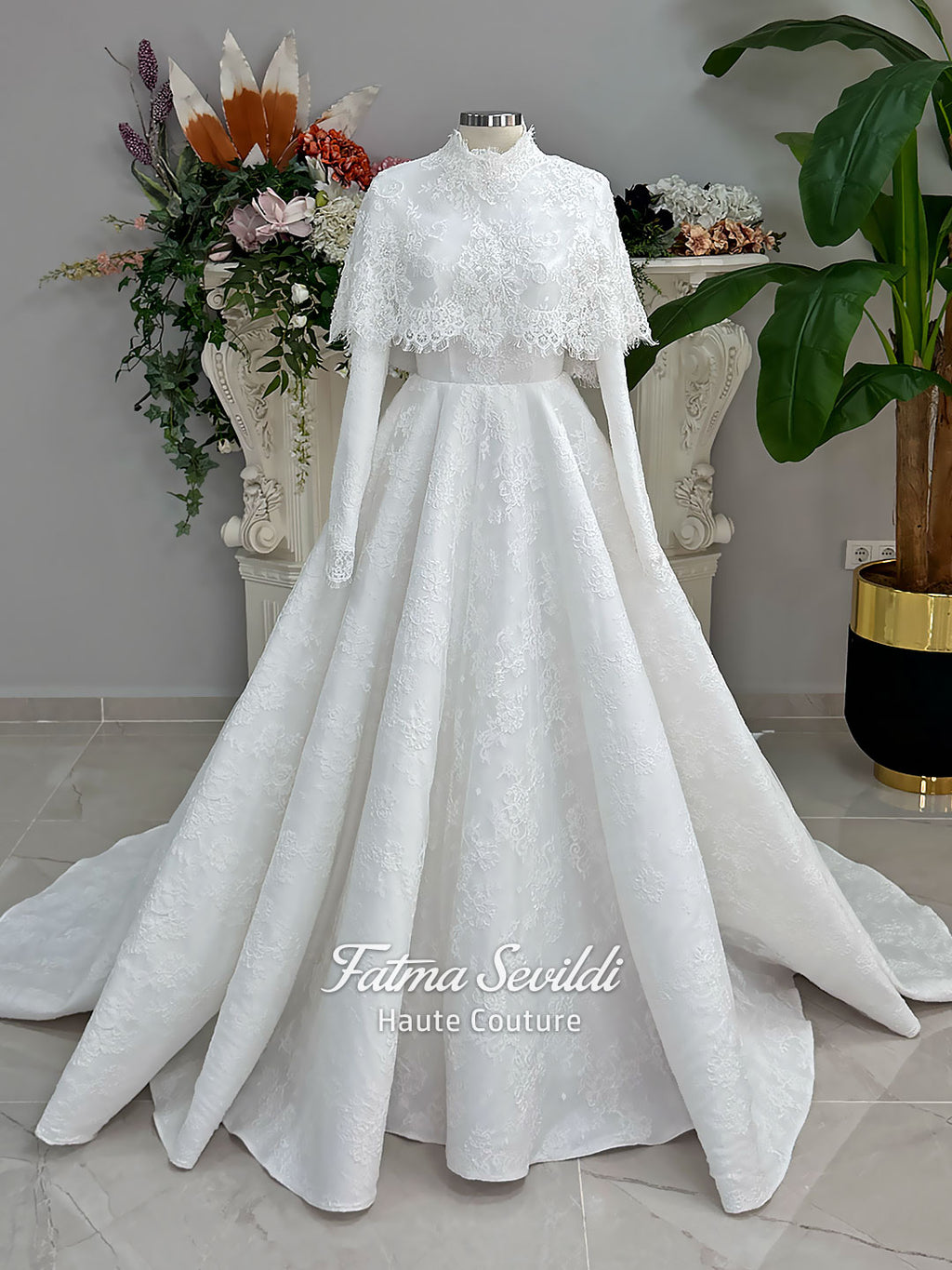Elegant hijab wedding dress with long sleeves, high neck, detachable lace cape, cathedral train, and premium lace veil included. Luxury modest bridal couture gown in white with floral lace detailing.