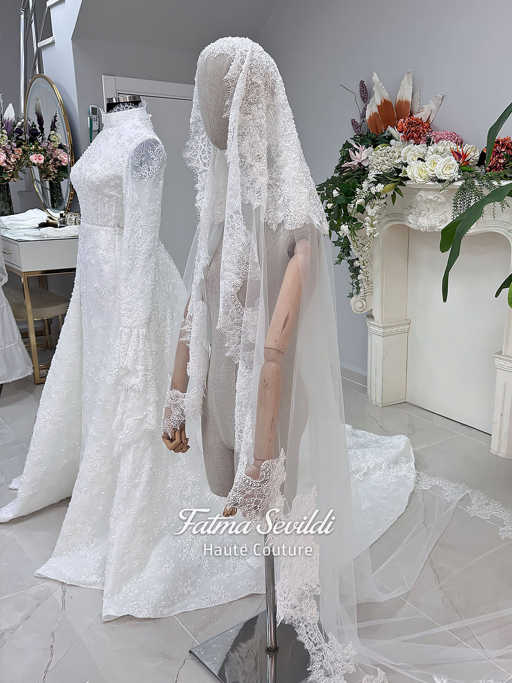 Luxury hijab wedding dress with long flounce sleeves, a high mock neckline, beaded floral lace, corset fit, mermaid silhouette, detachable overskirt, and included lace veil. Modest Muslim bridal gown shown from front, back, and detail views.