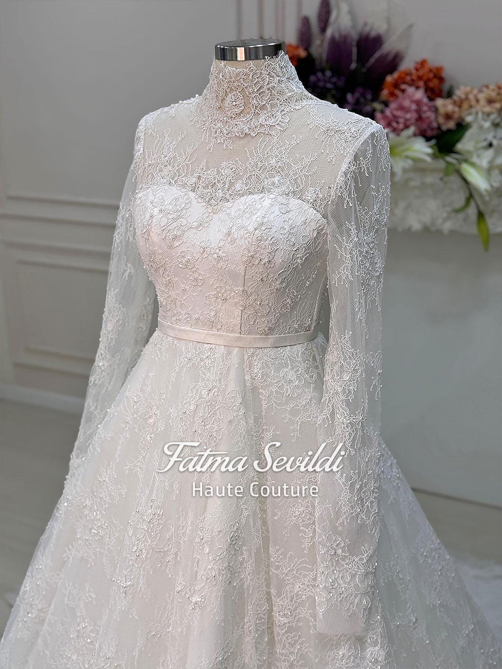 Elegant strapless lace wedding gown with floral embroidery, beaded details, corset back, and veil