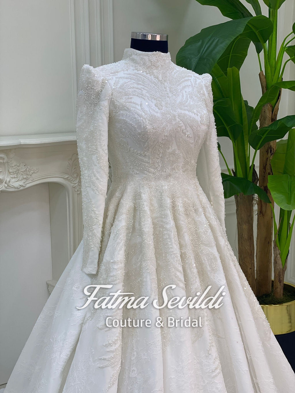 Elegant beaded lace Muslim wedding dress on mannequin with veil