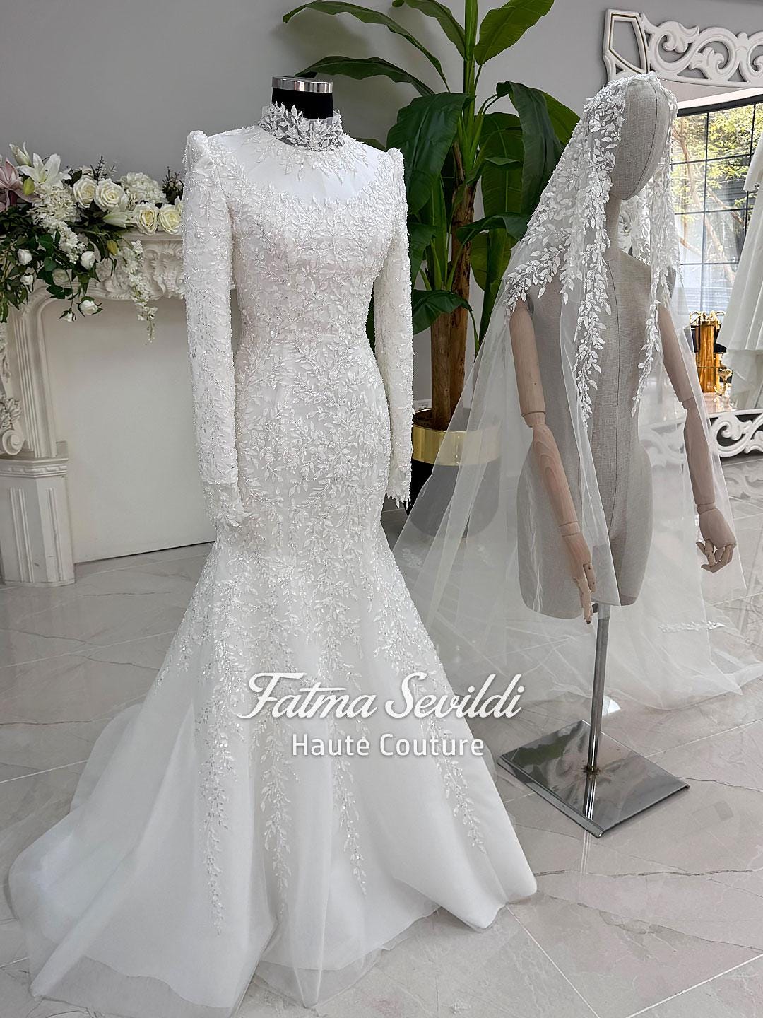 White mermaid wedding gown with long sleeves, high neck, beaded lace, and veiled hijab