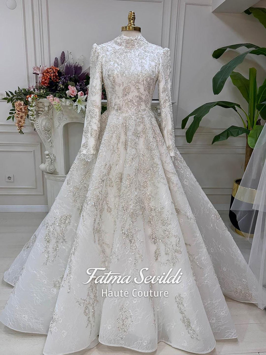 White long-sleeved wedding gown with silver embroidery, high neck, beaded lace skirt